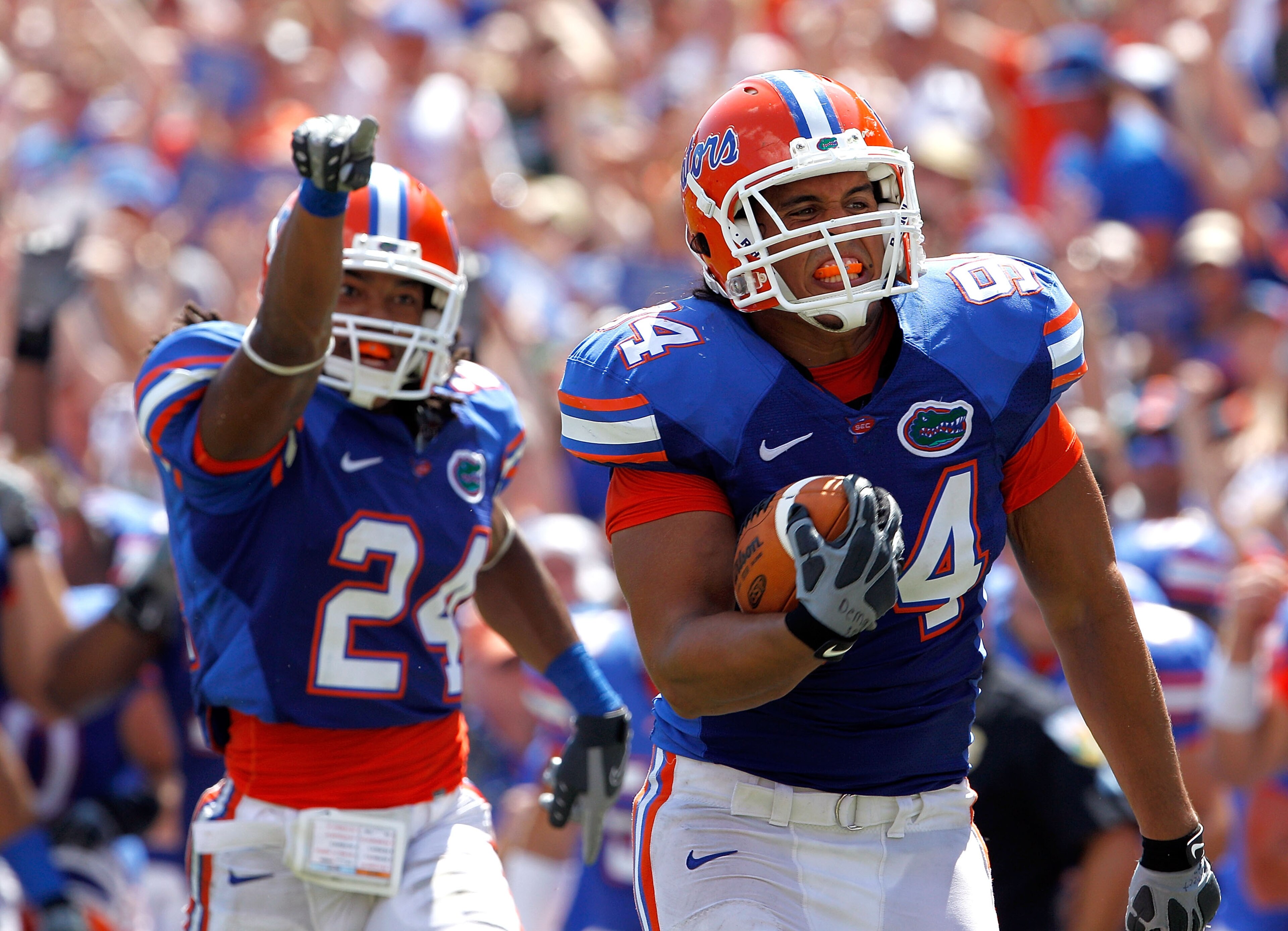 GAINESVILLE, FL - SEPTEMBER 11: Justin Trattou #94 of the Florida Gators runs for a touchdown after making an interception during a game against the South Florida Bulls at Ben Hill Griffin Stadium on September 11, 2010 in Gainesville, Florida. (Photo b GAINESVILLE, FL - SEPTEMBER 11: Justin Trattou #94 of the Florida Gators runs for a touchdown after making an interception during a game against the South Florida Bulls at Ben Hill Griffin Stadium on September 11, 2010 in Gainesville, Florida. (Photo b