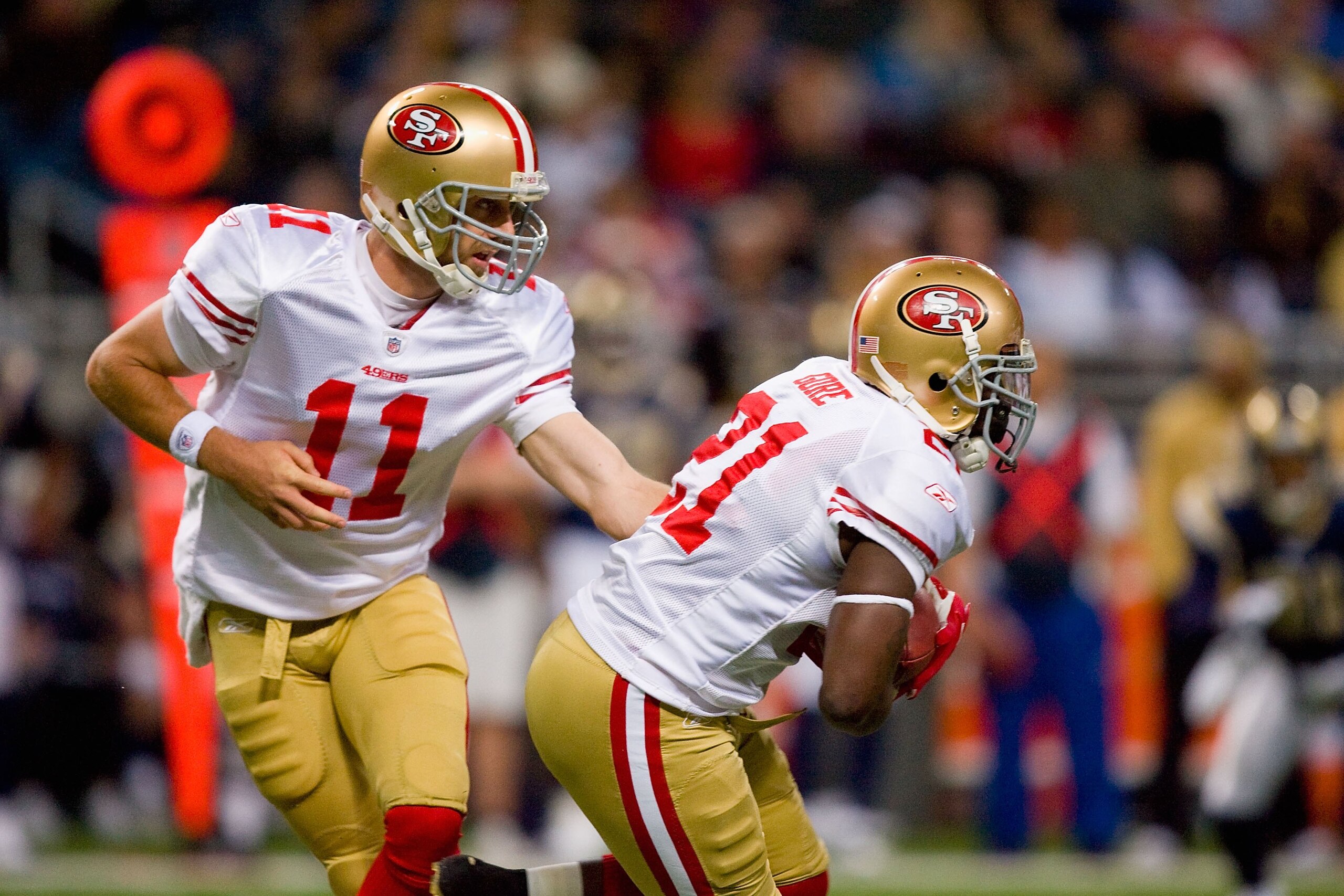ST. LOUIS - JANUARY 3: Quarterback Alex Smith #11 of the San Francisco 49ers hands off the ball to Frank Gore #21 during the game against the St. Louis Rams at the Edward Jones Dome on January 3, 2010 in St. Louis, Missouri.  The 49ers beat the Rams 28-6.