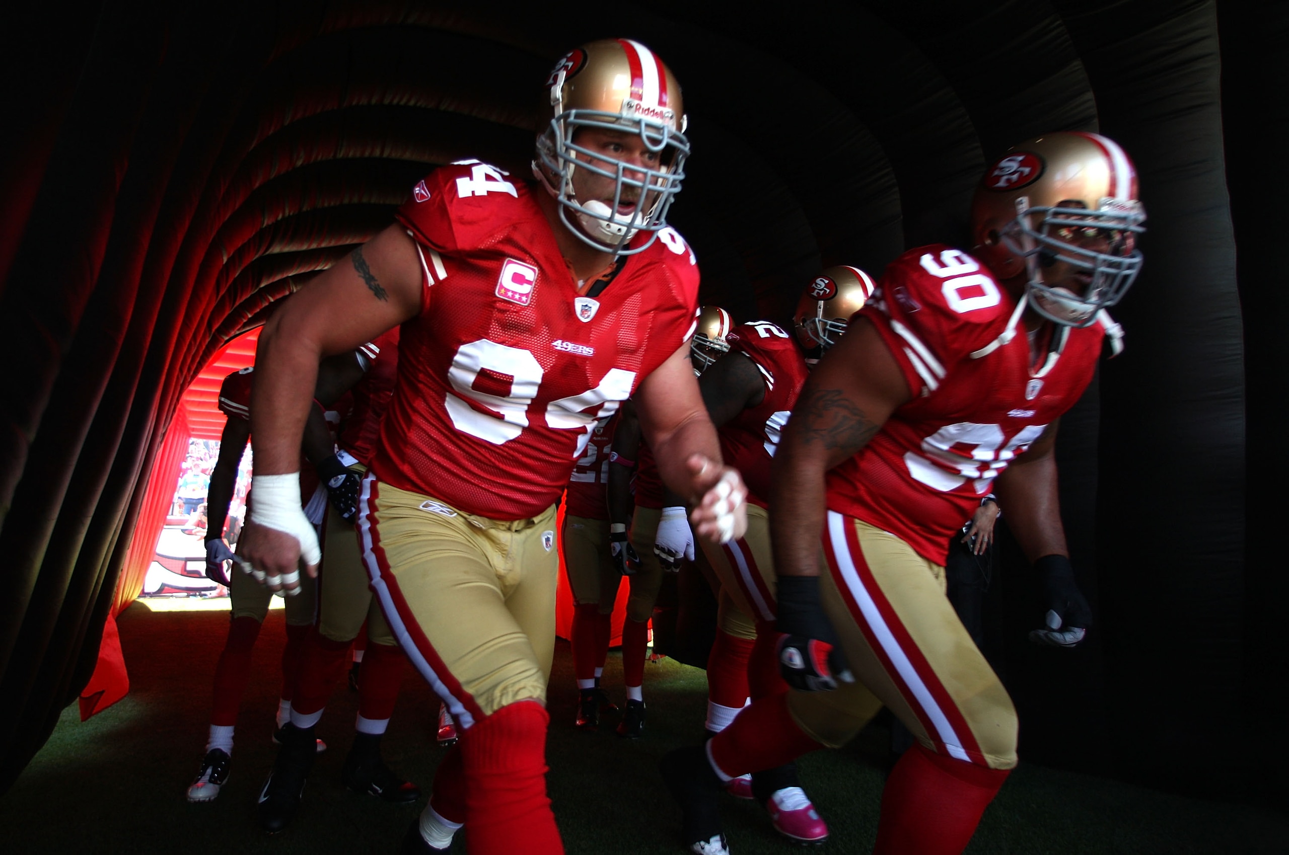 SAN FRANCISCO - OCTOBER 04:  Justin Smith #94 and Isaac Sopoaga #90 of the San Francisco 49ers enter the field against the St. Louis Rams during an NFL game on October 4, 2009 at Candlestick Park in San Francisco, California.  (Photo by Jed Jacobsohn/Gett