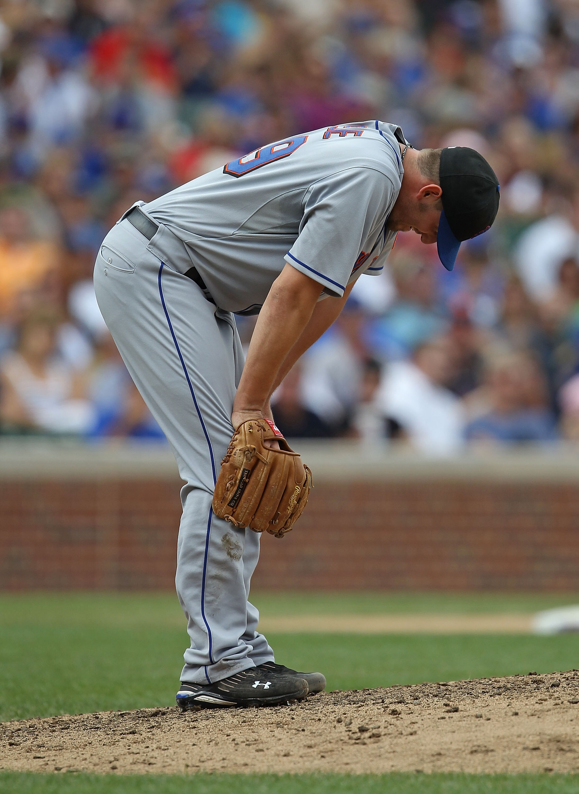 CHICAGO - SEPTEMBER 05: Starting pitcher Jonathan Niese #49 of the New York Mets reacts after slipping on the mound while pitching against the Chicago Cubs at Wrigley Field on September 5, 2010 in Chicago, Illinois. The Mets defeated the Cubs 18-5.  (Phot