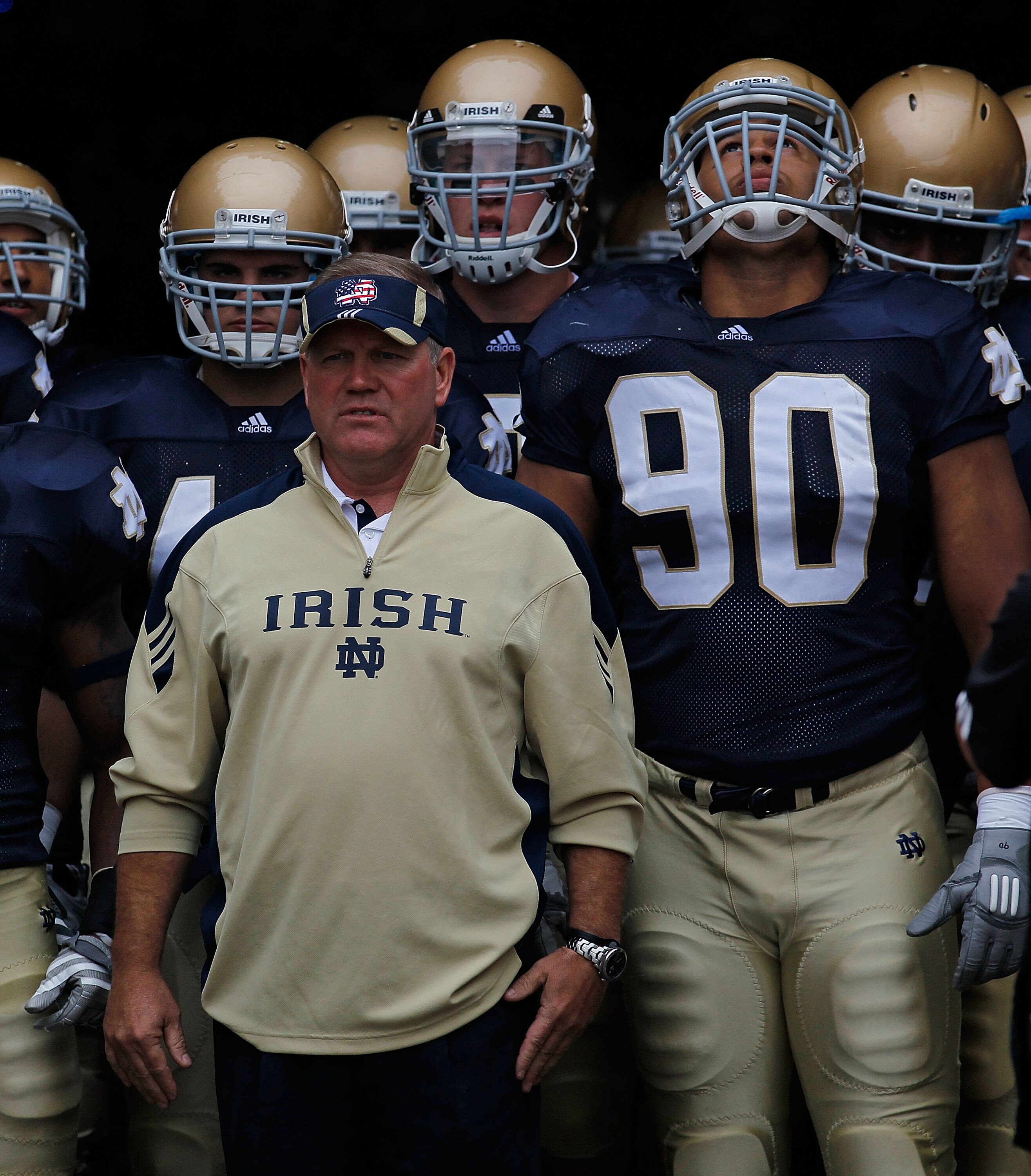 SOUTH BEND, IN - SEPTEMBER 11: Head coach Brian Kelly of the Notre Dame Fighting Irish waits to enter the field with his team including Carlo Calabrese #44 and Ethan Johnson #90 before a game against the Michigan Wolverines at Notre Dame Stadium on Septem