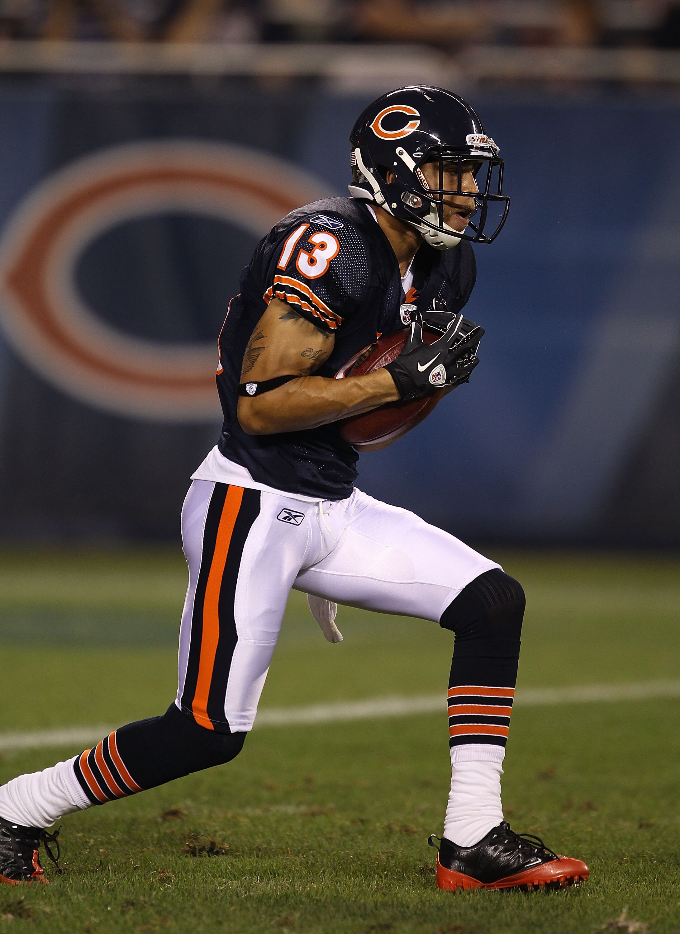 CHICAGO - AUGUST 21: Johnny Knox #13 of the Chicago Bears fields the ball during a preseason game against the Oakland Raiders at Soldier Field on August 21, 2010 in Chicago, Illinois. The Radiers defeated the Bears 32-17. (Photo by Jonathan Daniel/Getty I