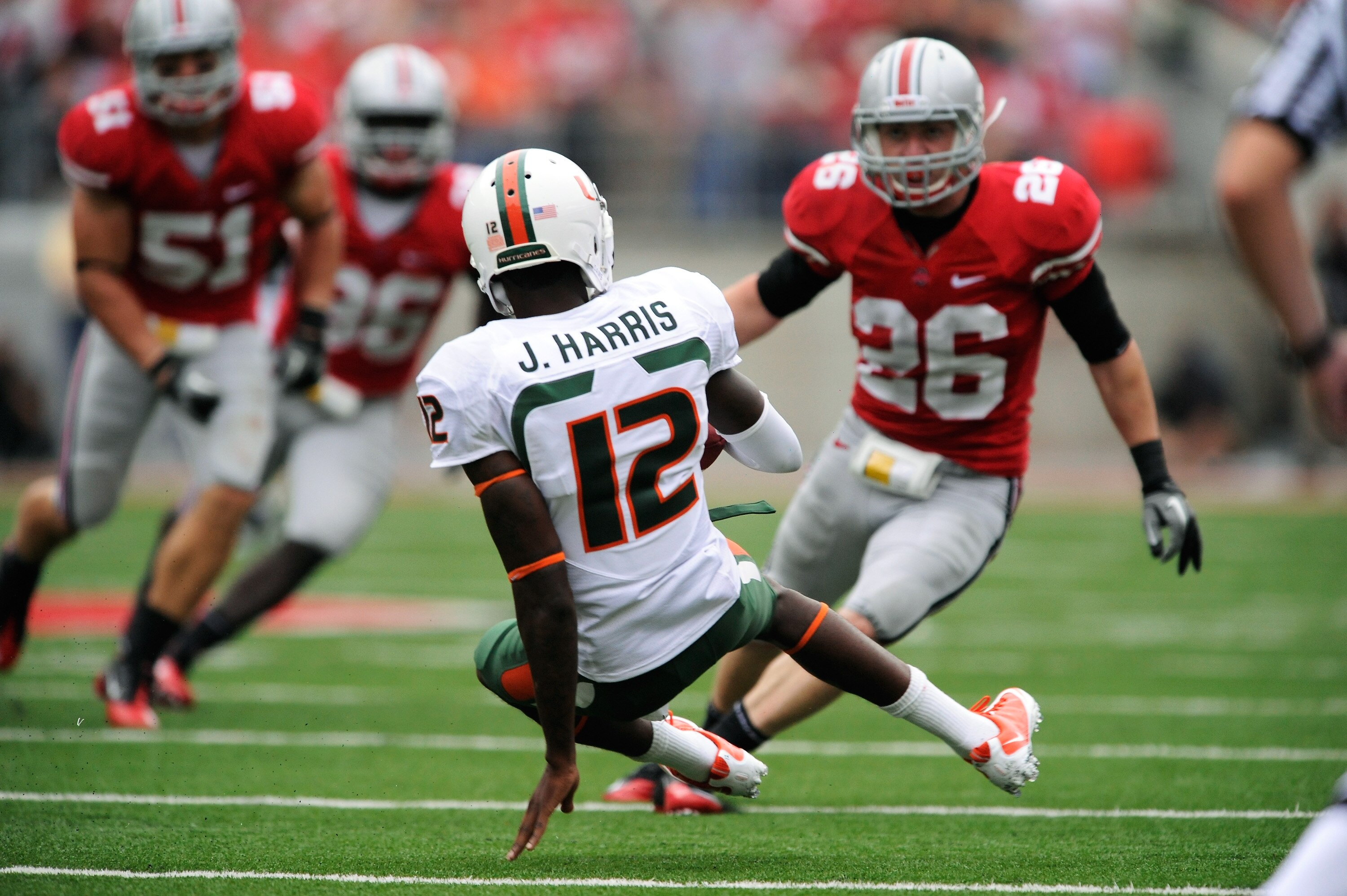 COLUMBUS, OH - SEPTEMBER 11: Quarterback Jacory Harris #12 of the Miami Hurricanes slides in to avoid be tackled by Tyler Moeller #26 of the Ohio State Buckeyes at Ohio Stadium on September 11, 2010 in Columbus, Ohio. (Photo by Jamie Sabau/Getty Images) COLUMBUS, OH - SEPTEMBER 11: Quarterback Jacory Harris #12 of the Miami Hurricanes slides in to avoid be tackled by Tyler Moeller #26 of the Ohio State Buckeyes at Ohio Stadium on September 11, 2010 in Columbus, Ohio. (Photo by Jamie Sabau/Getty Images)