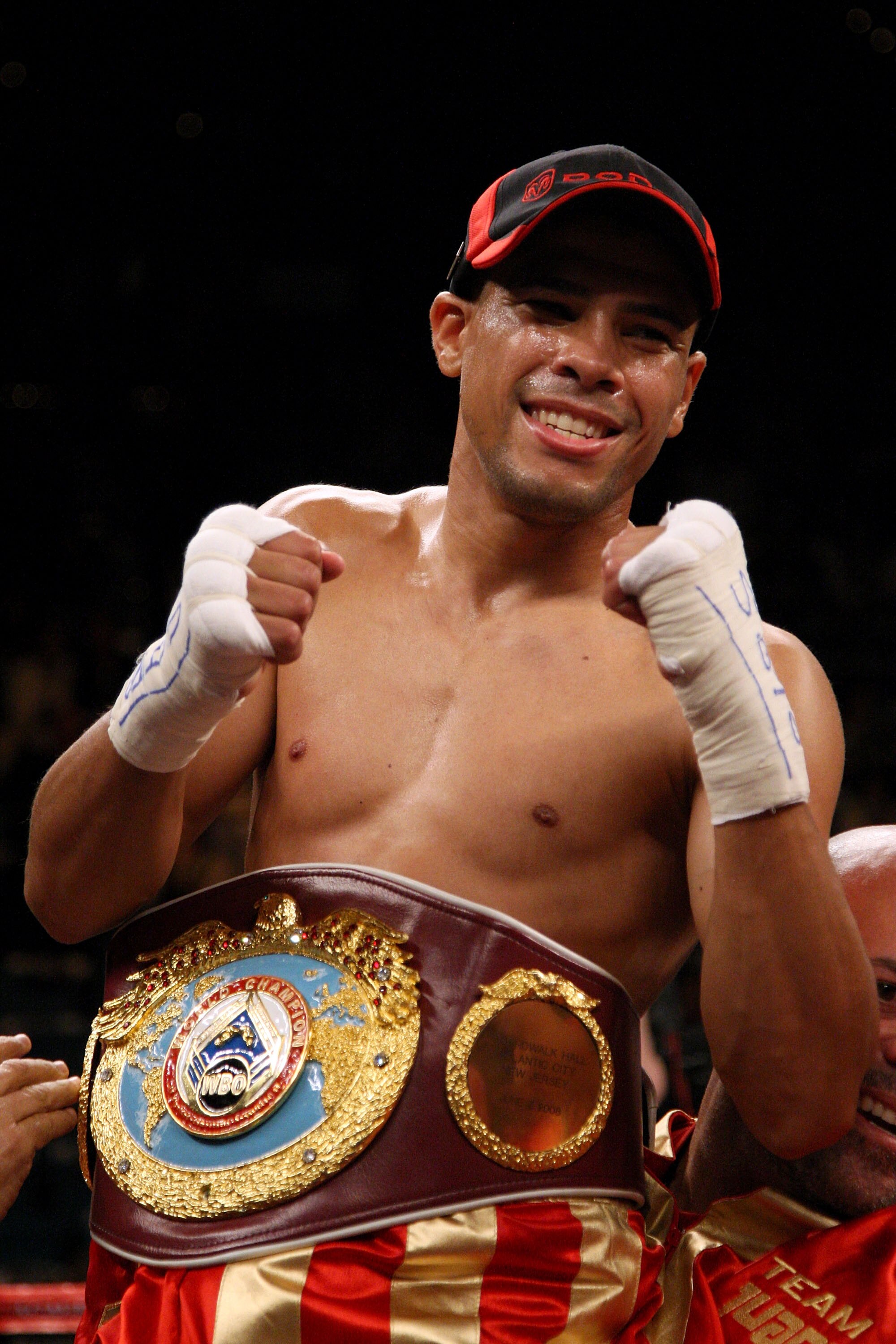 LAS VEGAS - DECEMBER 06:  (L-R) Juan Manuel Lopez of Puerto Rico celebrates his first round knockout of Sergio Medina of Argentina during their WBO junior featherweight title fight at the MGM Grand Garden Arena December 6, 2008 in Las Vegas, Nevada.  (Pho