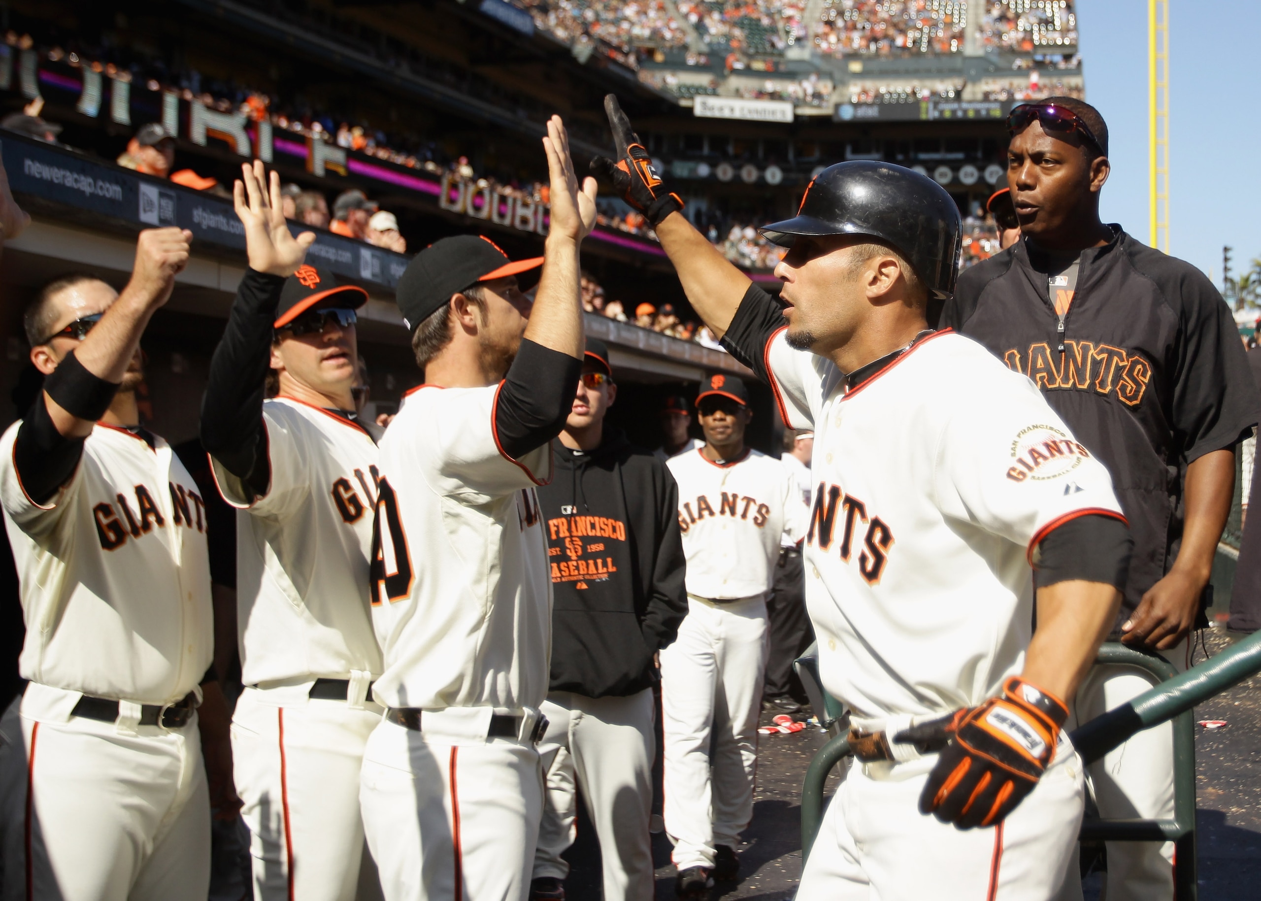 SAN FRANCISCO - AUGUST 29:  Andres Torres #56 of the San Francisco Giants is congratulated by teammates after he scored to give the Giants a 9-7 lead in the eighth inning of their game against the Arizona Diamondbacks at AT&T Park on August 29, 2010 in Sa