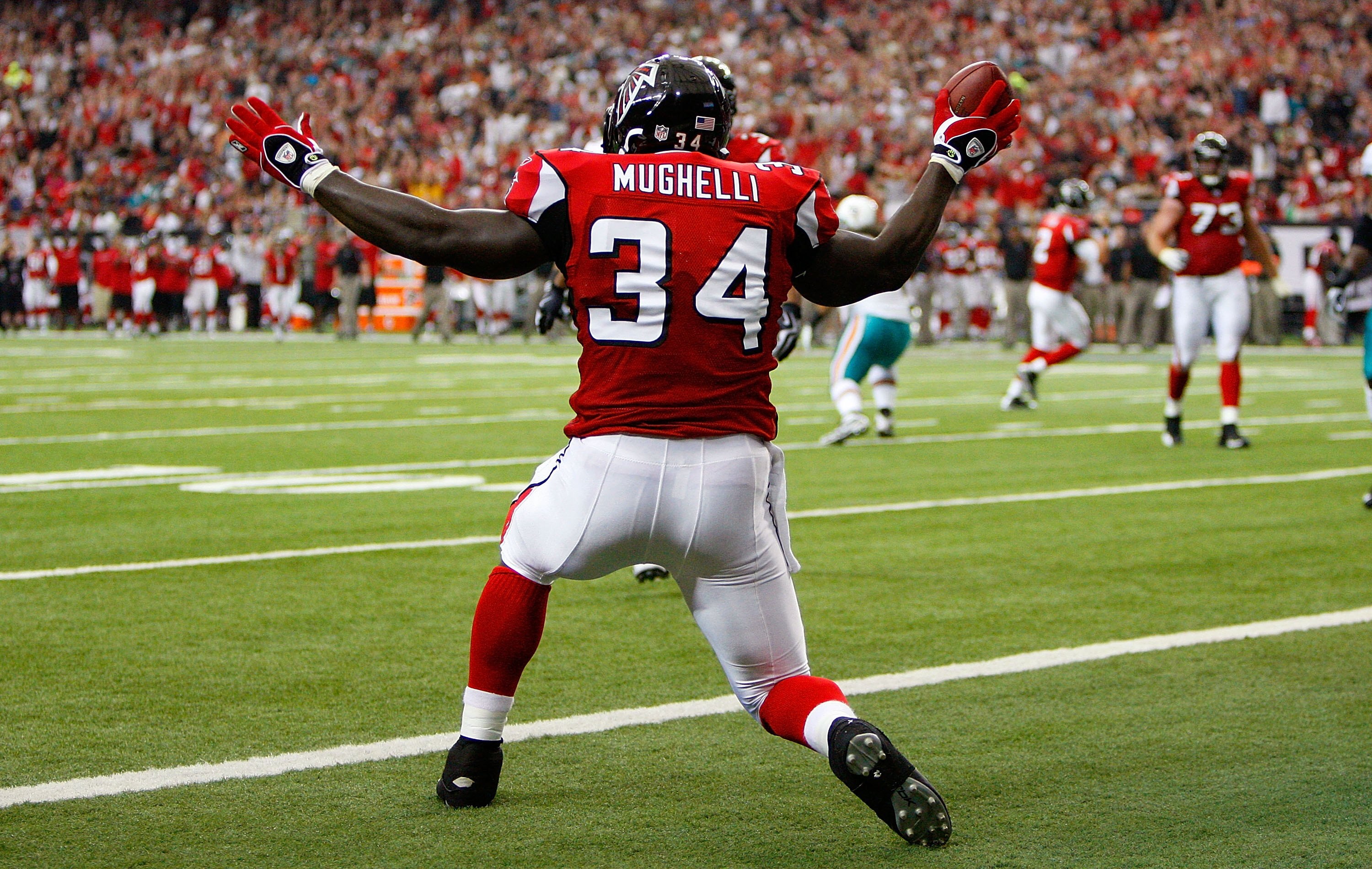 ATLANTA - SEPTEMBER 13:  Ovie Mughelli #34 of the Atlanta Falcons celebrates scoring a touchdown against the Miami Dolphins at Georgia Dome on September 13, 2009 in Atlanta, Georgia.  (Photo by Kevin C. Cox/Getty Images)