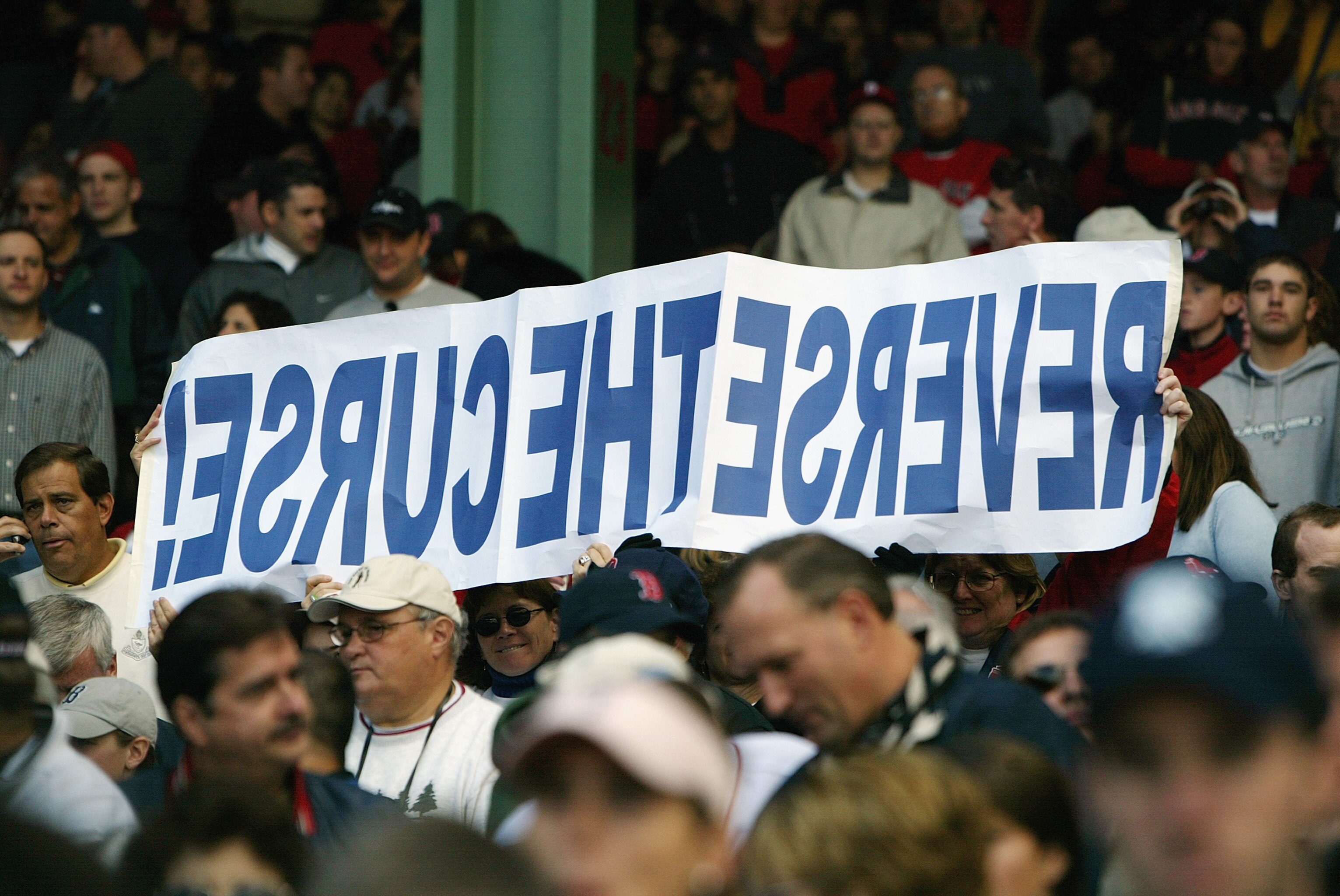 BOSTON - OCTOBER 5:  Boston Red Sox fans hold up a sign reading 'Reverse the Curse' during game four of the American League Division Series against the Oakland Athletics on October 5, 2003 at Fenway Park in Boston, Massachusetts.The Red Sox defeated the O