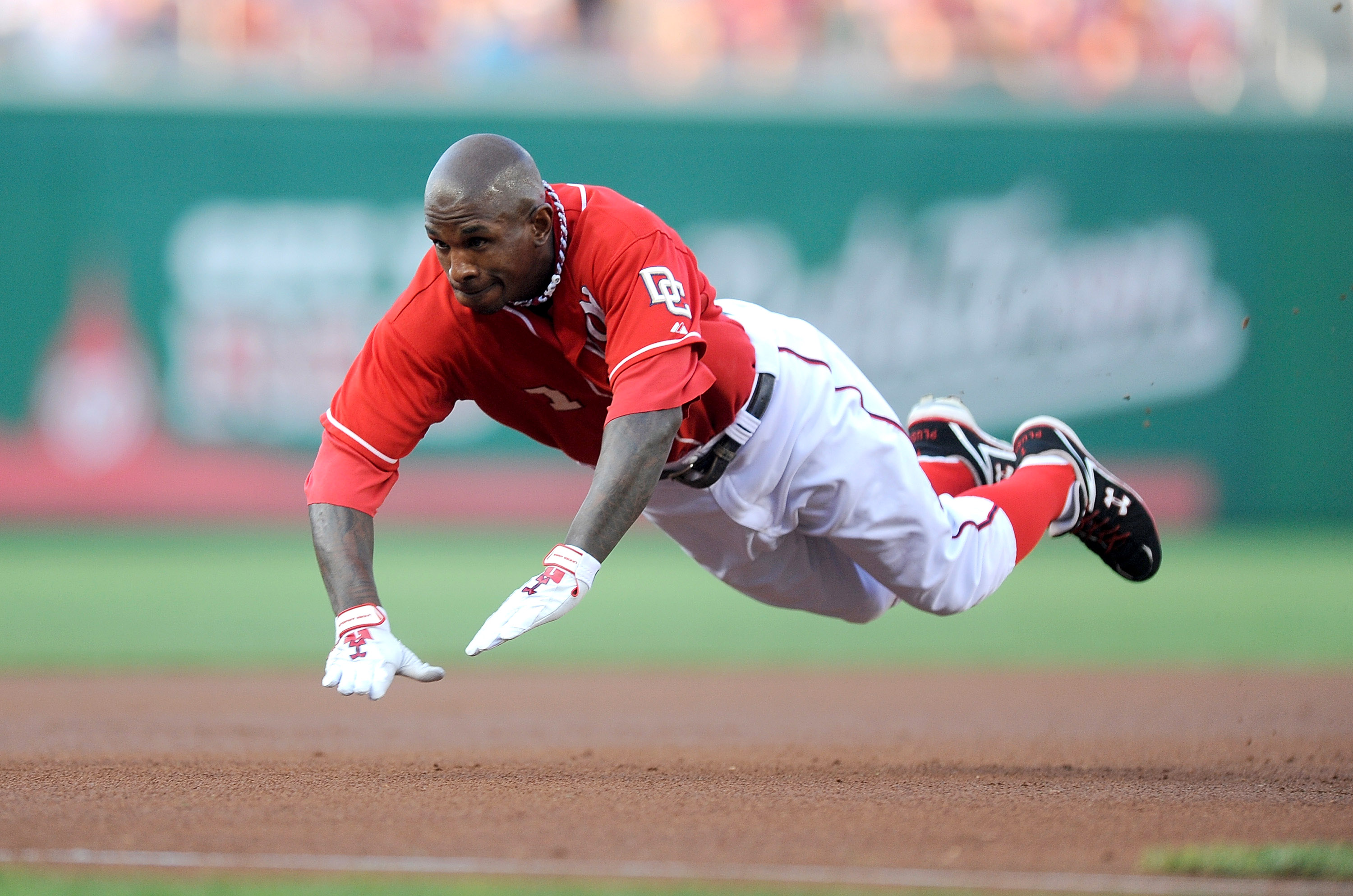 WASHINGTON - JULY 30:  Nyjer Morgan #1 of the Washington Nationals slides into third base with a triple in the first inning against the Philadelphia Phillies at Nationals Park on July 30, 2010 in Washington, DC.  (Photo by Greg Fiume/Getty Images)