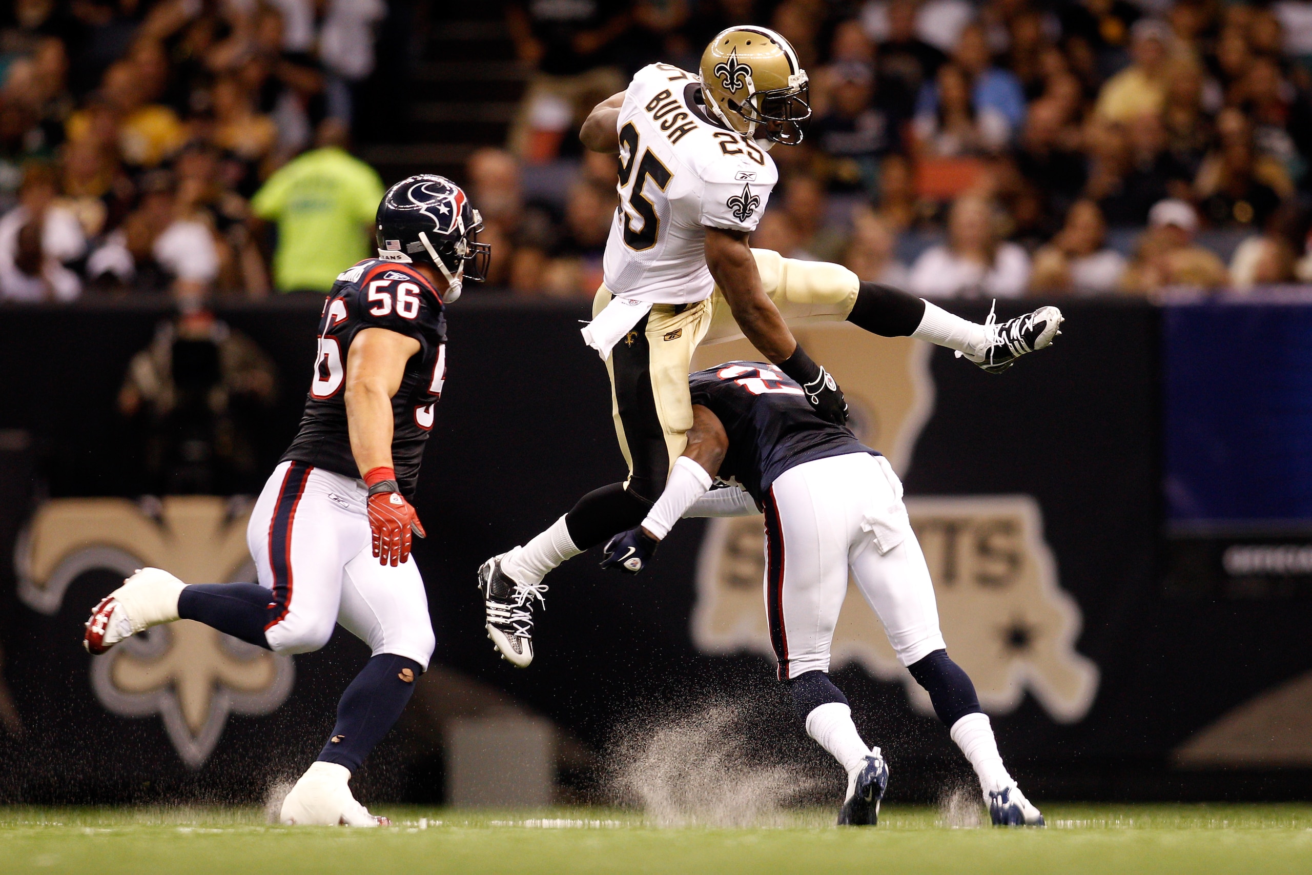 NEW ORLEANS - AUGUST 21: Reggie Bush #25 of the New Orleans Saints jumps over Brice McCain #21 of the Houston Texans at the Louisiana Superdome on August 21, 2010 in New Orleans, Louisiana. (Photo by Chris Graythen/Getty Images) NEW ORLEANS - AUGUST 21: Reggie Bush #25 of the New Orleans Saints jumps over Brice McCain #21 of the Houston Texans at the Louisiana Superdome on August 21, 2010 in New Orleans, Louisiana. (Photo by Chris Graythen/Getty Images)