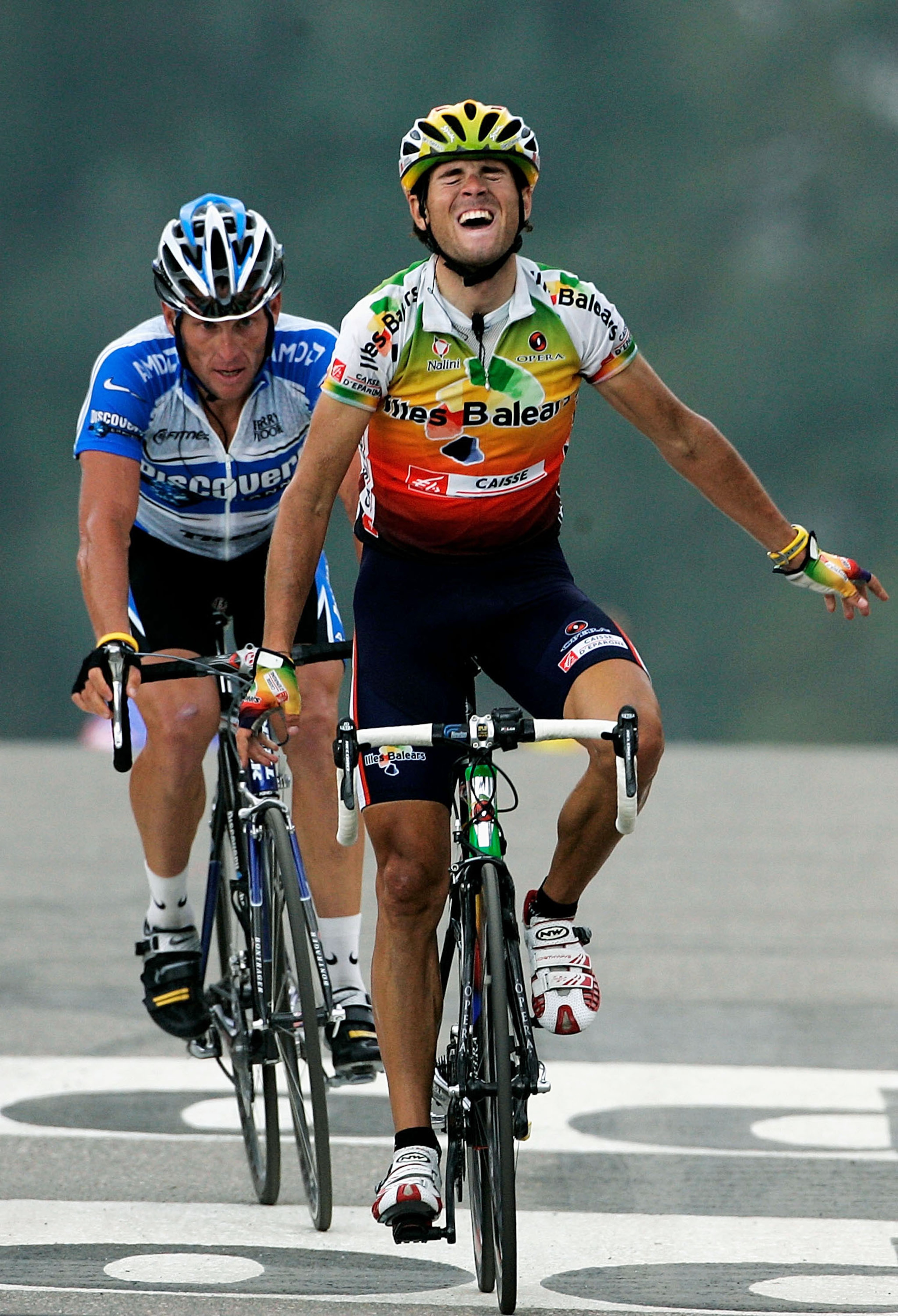 COURCHEVEL, FRANCE - JULY 12:  Alejandro Valverde of Illes Balears crosses the finish line to win Stage 10 as Lance Armstrong (L) of the U.S. and Discovery Channel team finishes second during the 92nd Tour de France between Grenoble and Courchevel July 12