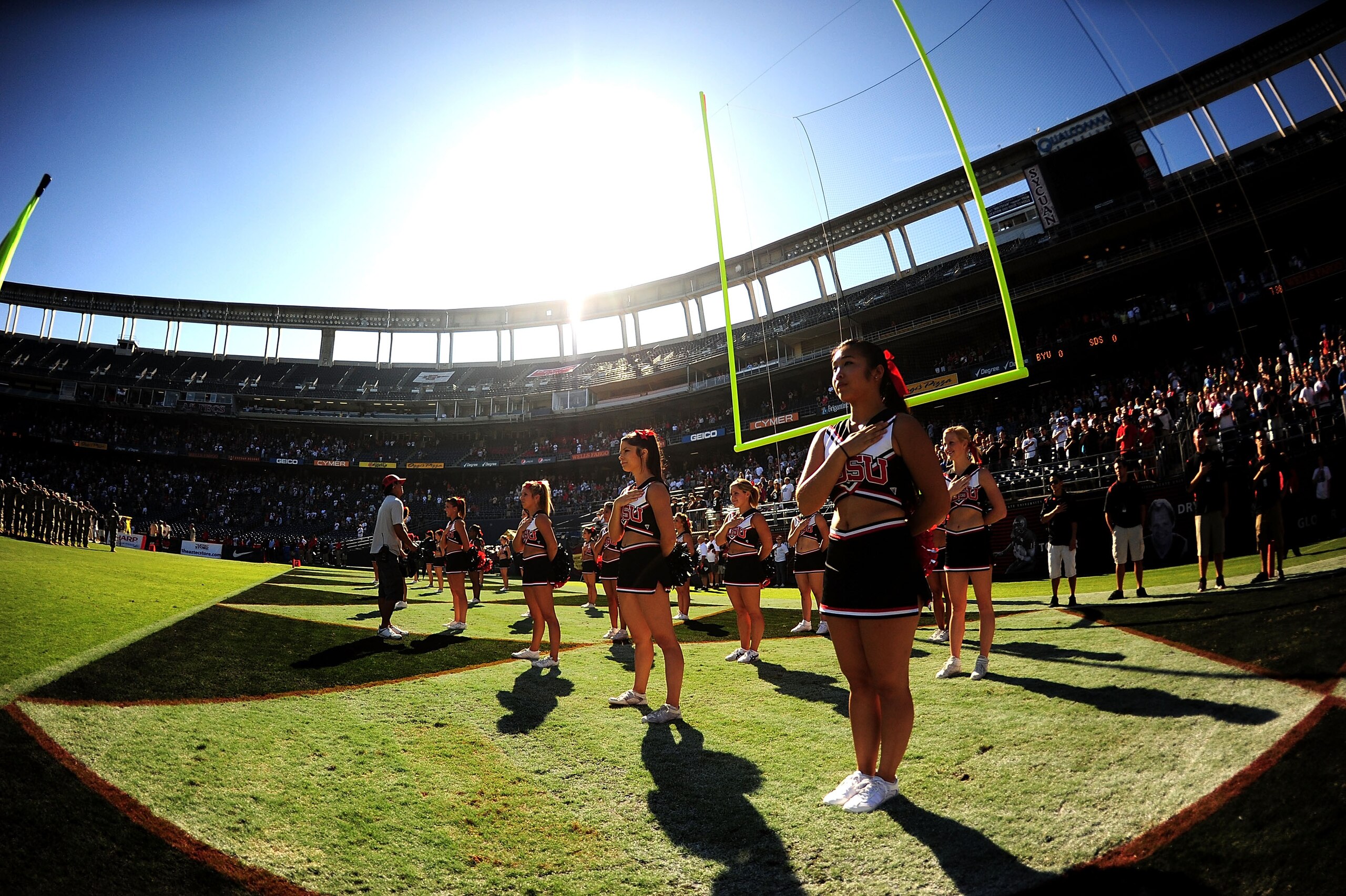 SAN DIEGO - OCTOBER 17: The cheerleaders of San Diego State Aztecs solute to the National Anthem before the game against BYU Cougars at Qualcomm Stadium on October 17, 2009 in San Diego, California.  (Photo by Jacob de Golish/Getty Images)