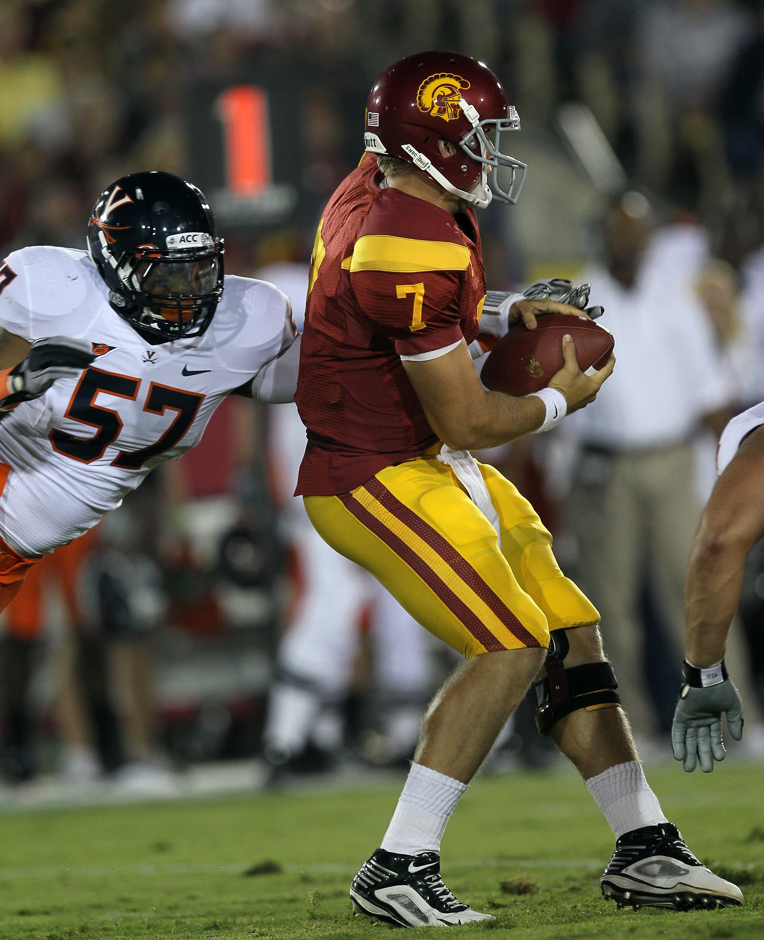 LOS ANGELES - SEPTEMBER 11:  Linebacker Darnell Carter #57 of the Virginia Cavaliers forces a fumble as he sacks quarterback Matt Barkley #7 of the USC Trojans at Los Angeles Memorial Coliseum on September 11, 2010 in Los Angeles, California. (Photo by St