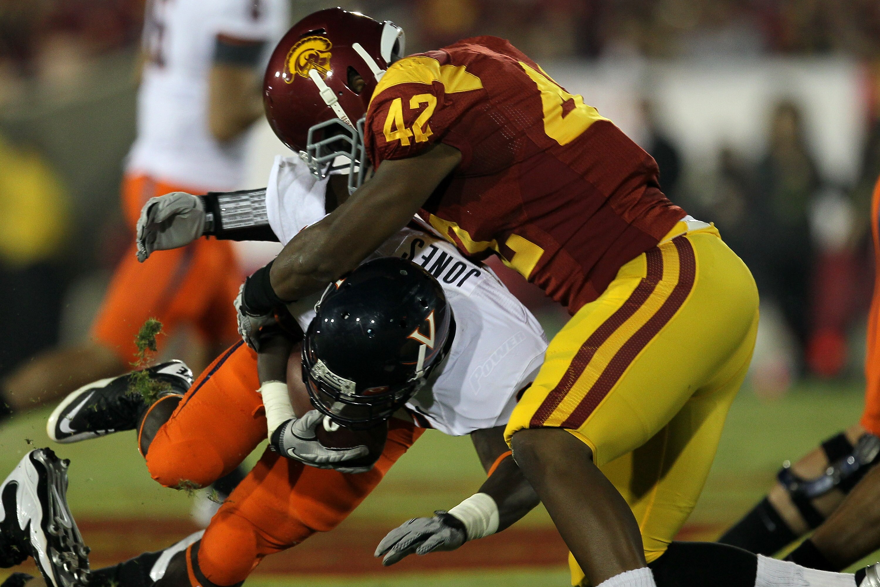 LOS ANGELES - SEPTEMBER 11:  Linebacker Devon Kennard #42 of the USC Trojans tackles running back  Perry Jones #33 of the Virginia Cavaliers at Los Angeles Memorial Coliseum on September 11, 2010 in Los Angeles, California. (Photo by Stephen Dunn/Getty Im