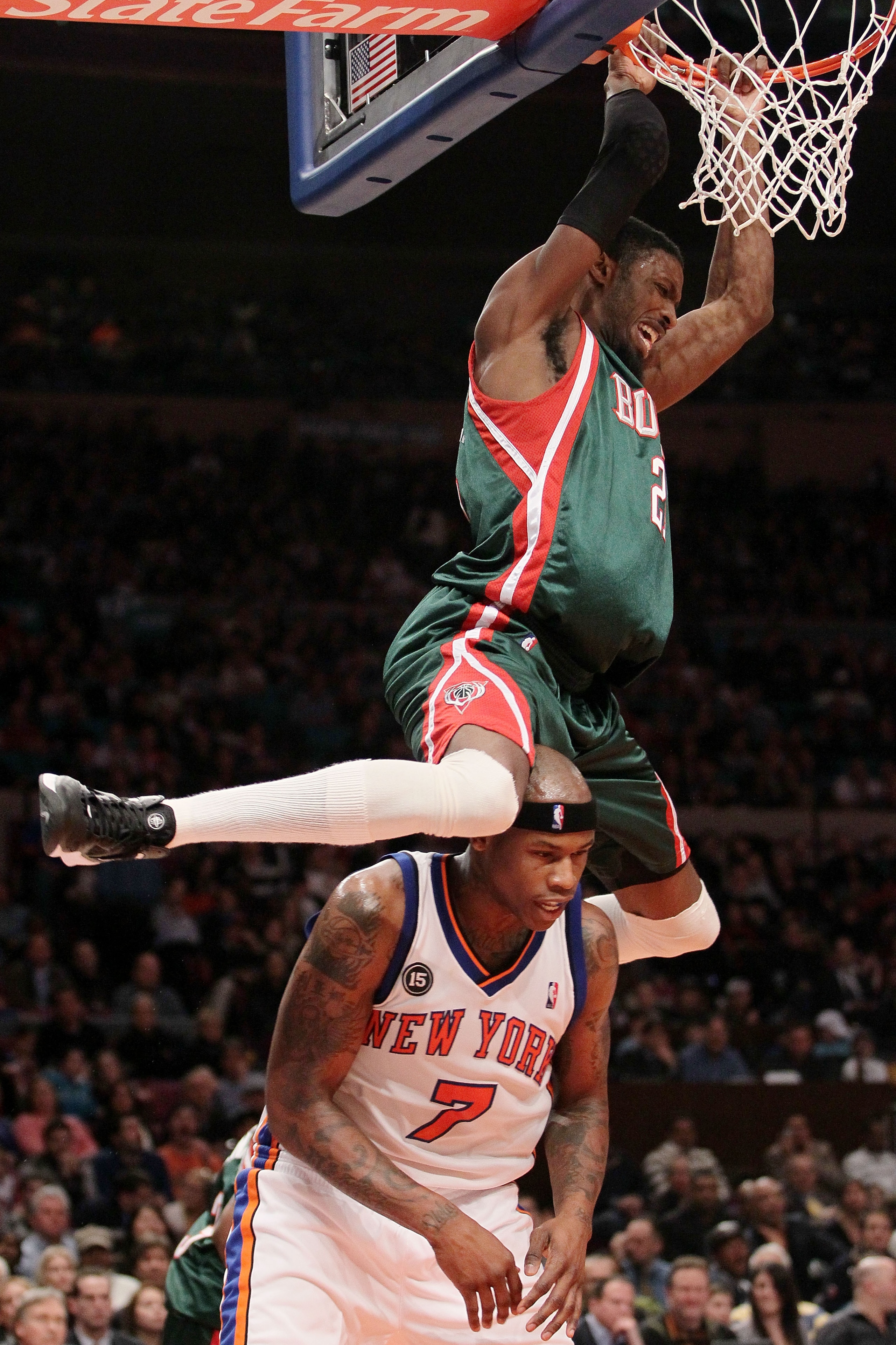 NEW YORK - FEBRUARY 05: Hakim Warrick #21 of the Milwaukee Bucks swings on the ring after dunking on Al Harrington #7 of the New York Knicks at Madison Square Garden February 5, 2010 in New York City. NOTE TO USER: User expressly acknowledges and agrees t