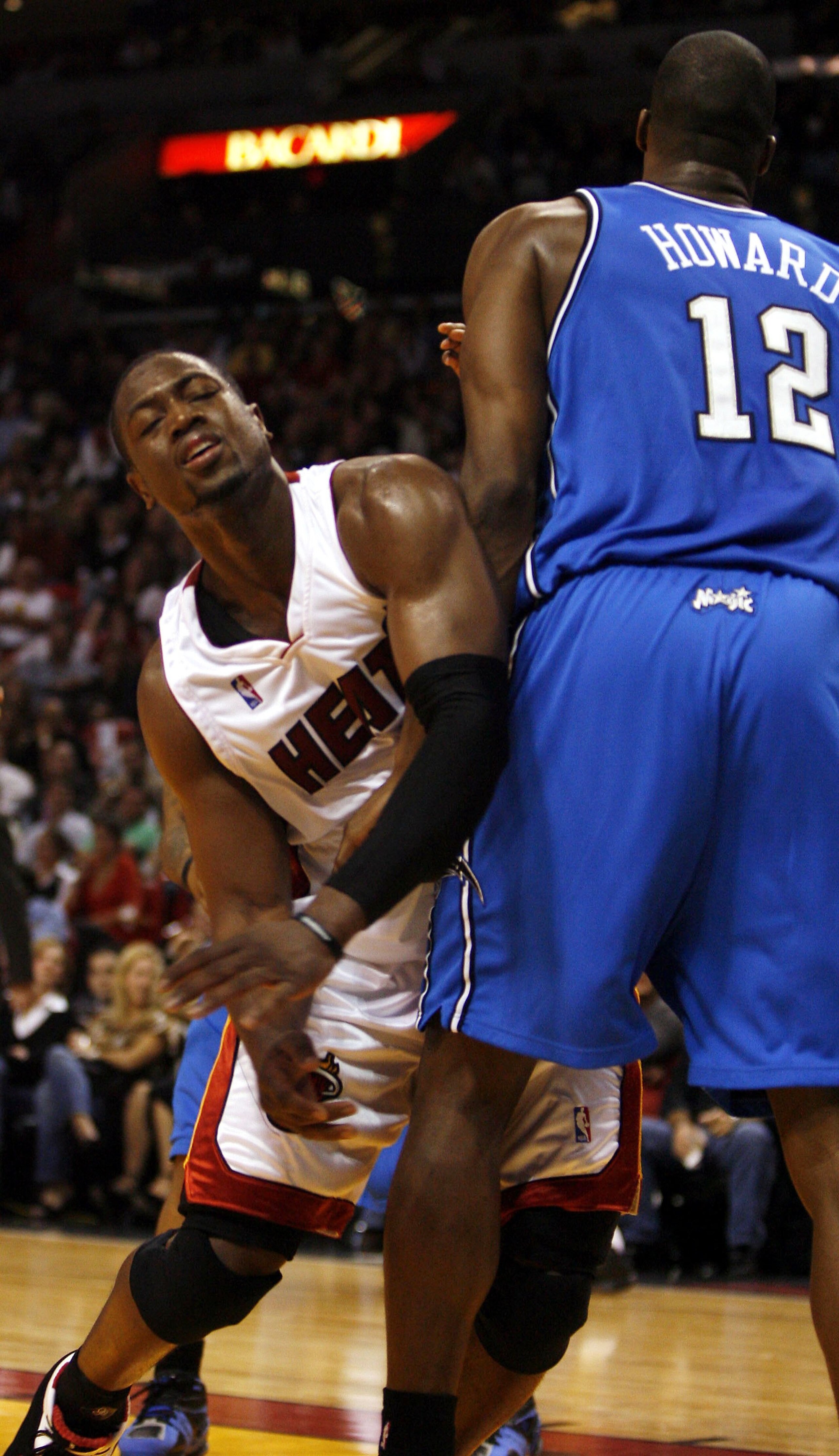 MIAMI - NOVEMBER 24: Guard Dwyane Wade #3 of the Miami Heat bumps into forward Dwight Howard #12 of the Orlando Magic in the first half on November 24, 2006 at the American Airlines Arena in Miami, Florida. NOTE TO USER: User expressly acknowledges and a MIAMI - NOVEMBER 24: Guard Dwyane Wade #3 of the Miami Heat bumps into forward Dwight Howard #12 of the Orlando Magic in the first half on November 24, 2006 at the American Airlines Arena in Miami, Florida. NOTE TO USER: User expressly acknowledges and a