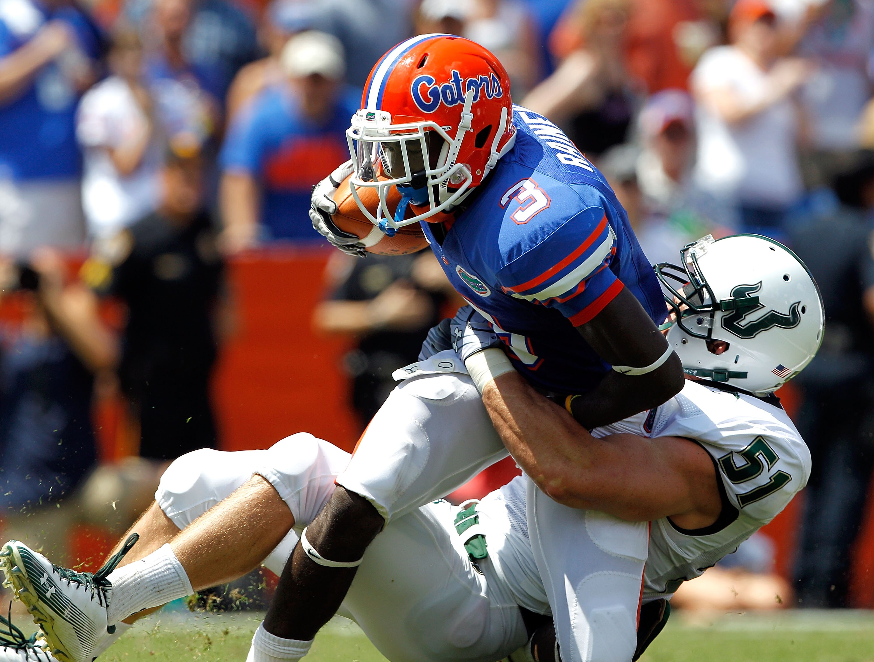 GAINESVILLE, FL - SEPTEMBER 11:  Chris Rainey #3 of the Florida Gators is tackled by Armando Sanchez #51 of the South Florida Bulls during a game at Ben Hill Griffin Stadium on September 11, 2010 in Gainesville, Florida.  (Photo by Sam Greenwood/Getty Ima
