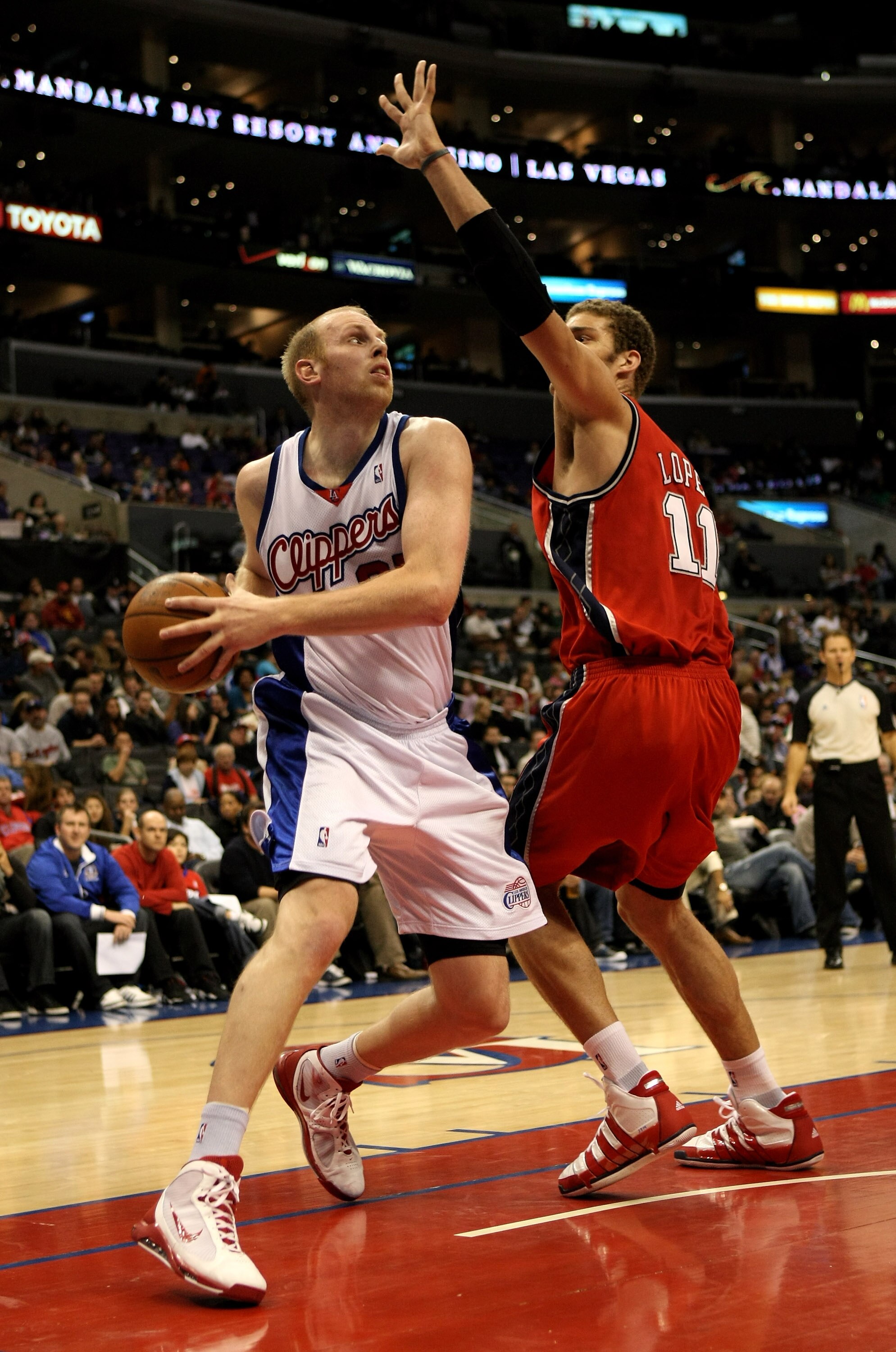 LOS ANGELES - JANUARY 18:  Chris Kaman #35 of the Los Angeles Clippers controls the ball against Brook Lopez #11 of the New Jersey Nets on January 18, 2010 at Staples Center in Los Angeles, California. The Clippers won 106-95.  NOTE TO USER: User expressl