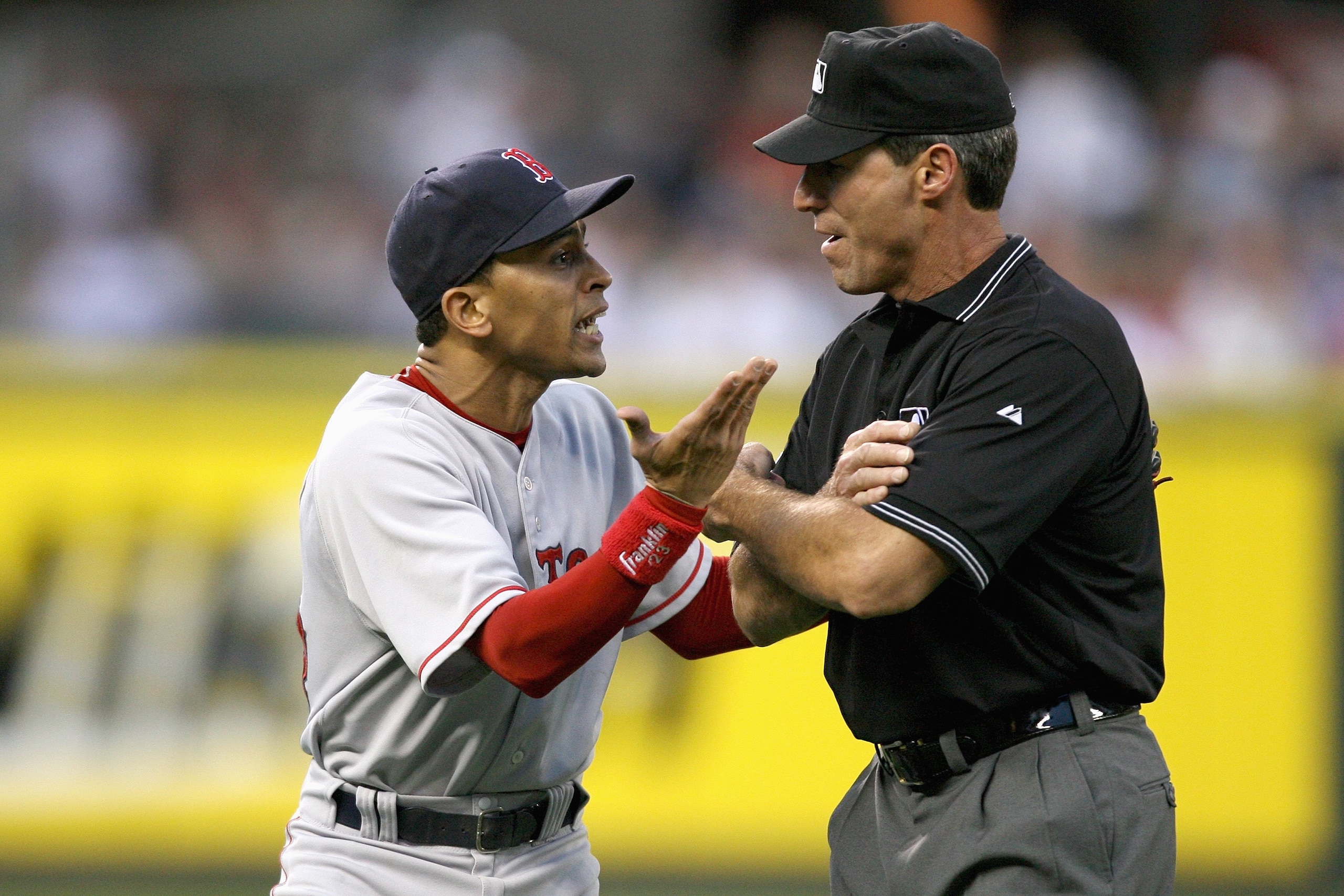 SEATTLE - MAY 27: Shortstop Julio Lugo #23 of the Boston Red Sox argues with third base umpire Angel Hernandez after being ejected in the fifth inning against the Seattle Mariners May 27, 2008 at Safeco Field in Seattle, Washington. (Photo by Otto Greule