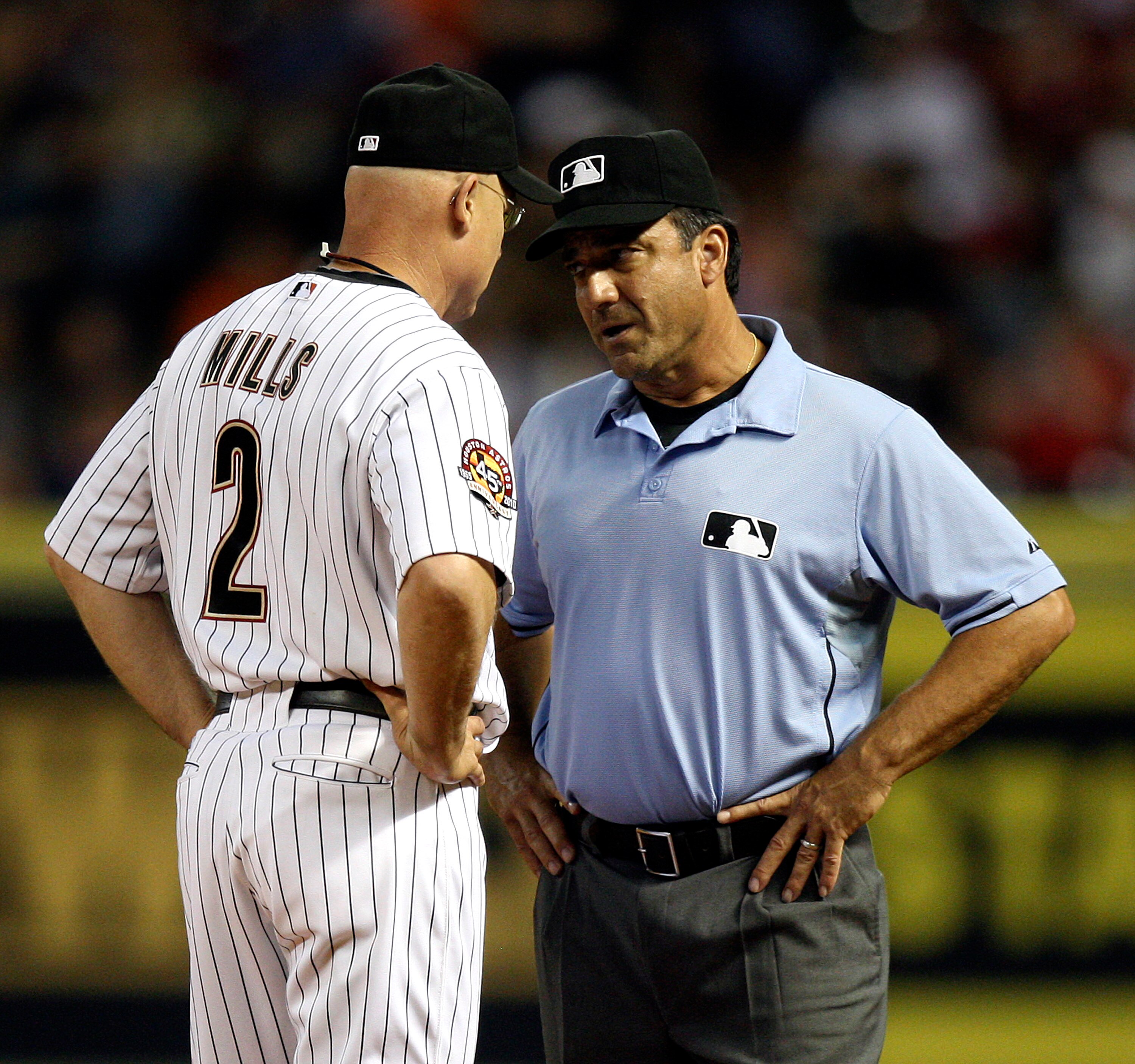HOUSTON - JULY 30:  Houston Astros manager Brad Mills #2 has words with first base umpire Phil Cuzzi after calling Michael Bourn out on a close call at first base against the Milwaukee Brewers at Minute Maid Park on July 30, 2010 in Houston, Texas.  (Phot