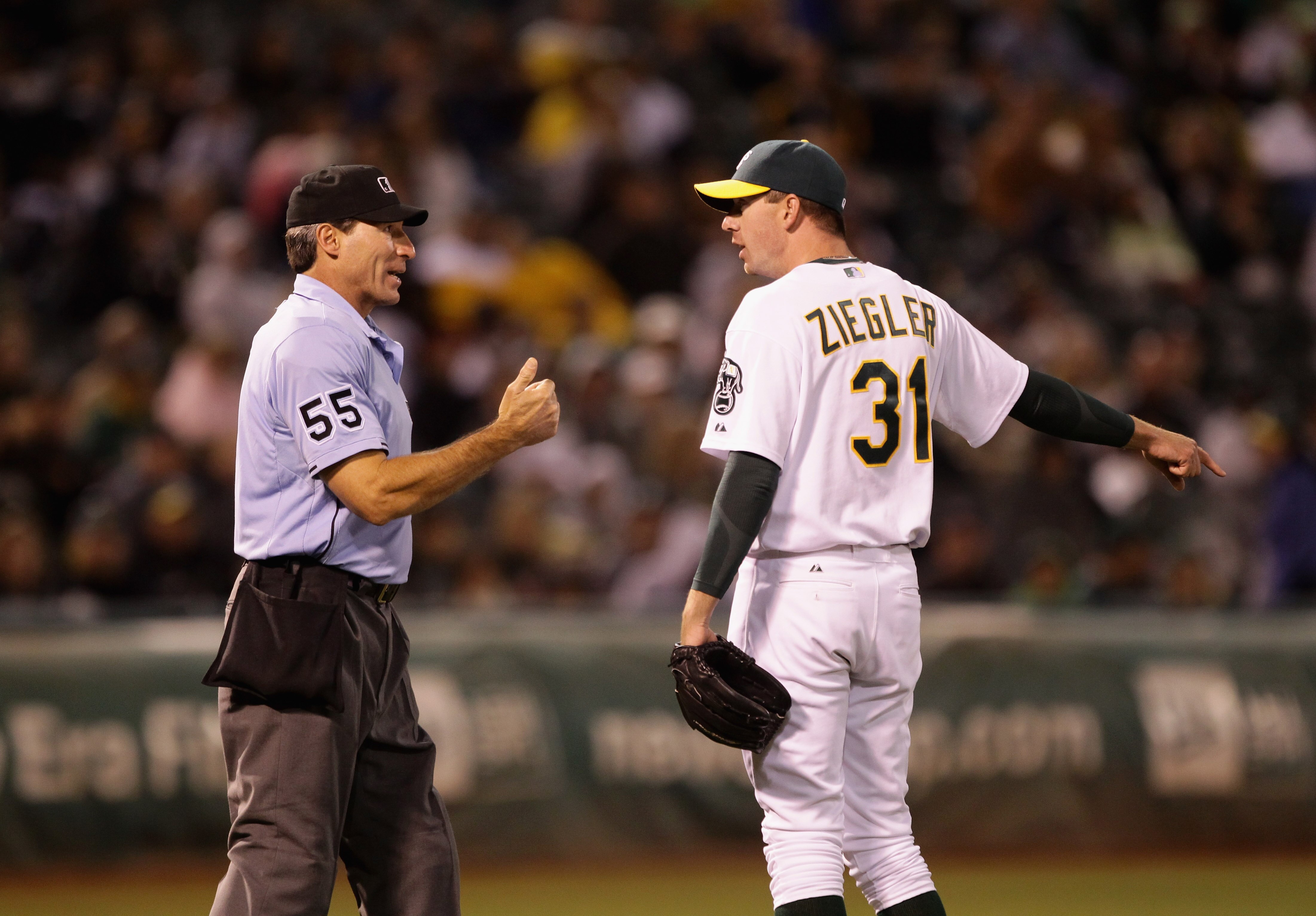 OAKLAND, CA - AUGUST 06:  Brad Ziegler #31 of the Oakland Athletics argues with home plate umpire Angel Hernandez after Henandez called Ziegler for a balk that scored Elvis Andrus #1 of the Texas Rangers to give the Rangers a 5-1 lead in the eighth inning