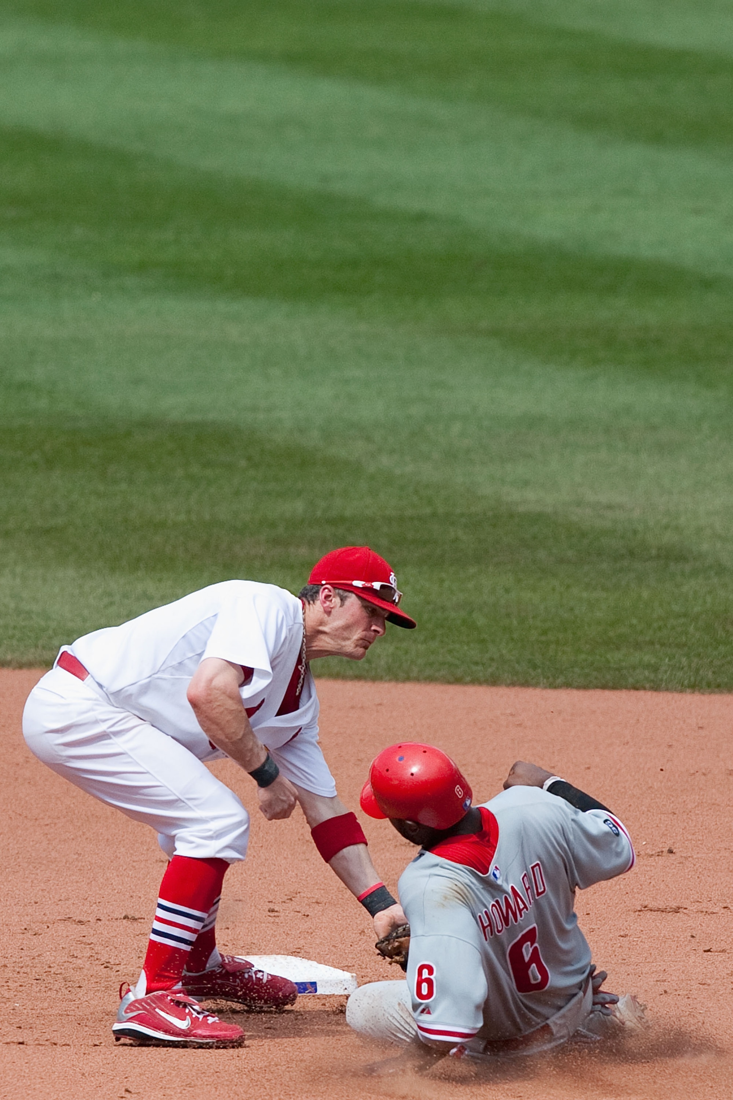 ST. LOUIS - JULY 22: Brendan Ryan #13 of the St. Louis Cardinals tags out Ryan Howard #6 of the Philadelphia Phillies at Busch Stadium on July 22, 2010 in St. Louis, Missouri. The Phillies defeated the Cardinals 2-0.  (Photo by Dilip Vishwanat/Getty Image