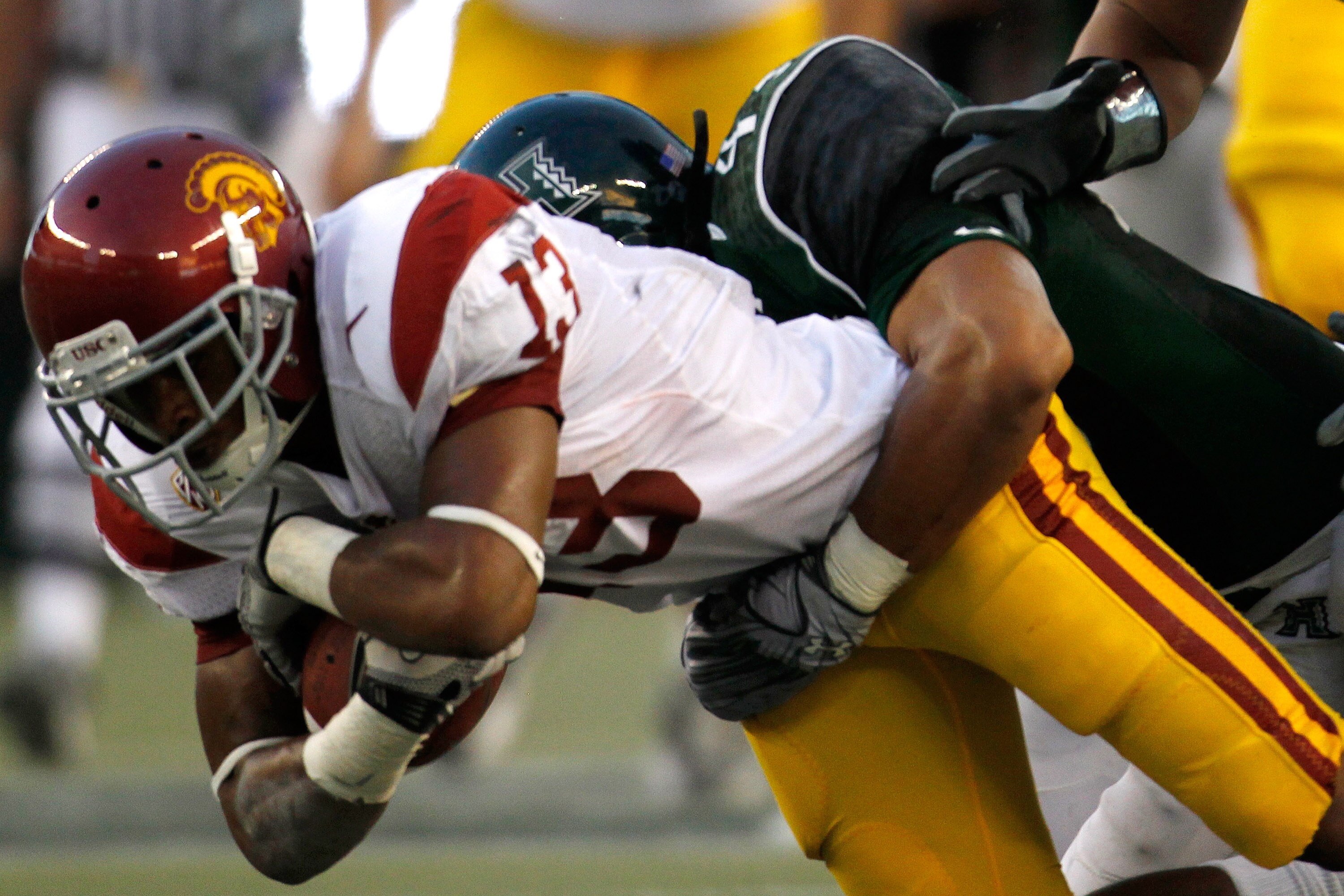 HONOLULU - SEPTEMBER 2:  Wide receiver Robert Woods #13 of the University of Southern California Trojans is taken down during first half action against the University of Hawaii Warriors at Aloha Stadium September 2, 2010 in Honolulu, Hawaii. (Photo by Ken