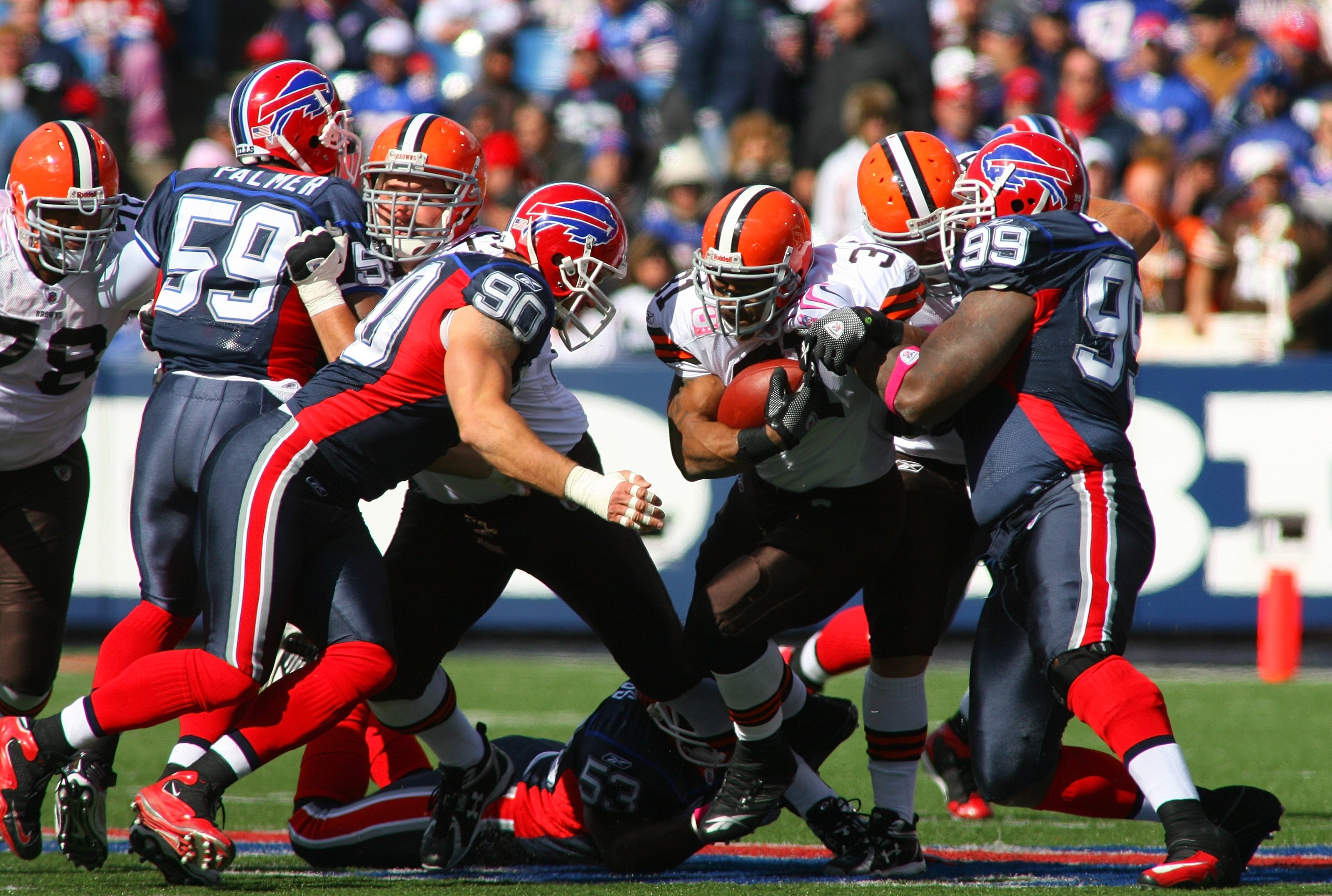 ORCHARD PARK, NY - OCTOBER 11:  Jamal Lewis #31 of the Cleveland Browns runs the ball against Marcus Stroud #99 and Chris Kelsay #90 of the Buffalo Bills during their NFL game at Ralph Wilson Stadium on October 11, 2009 in Orchard Park, New York. The Brow