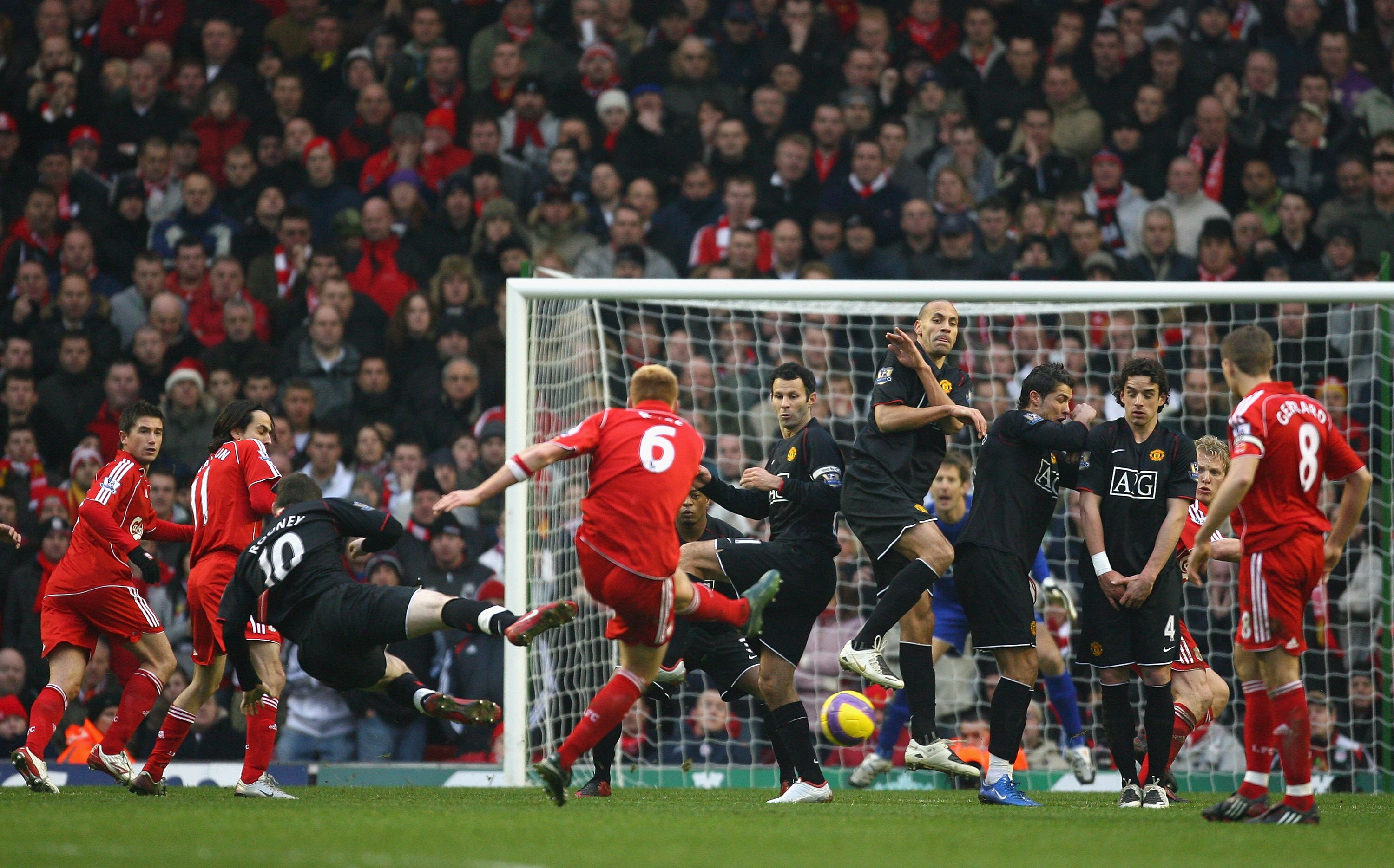 LIVERPOOL, UNITED KINGDOM - DECEMBER 16:   John Arne Riise of Liverpool shoots towards the Manchester United wall from a free kick during the Barclays Premier League match between Liverpool and Manchester United at Anfield on December 16, 2007 in Liverpoo
