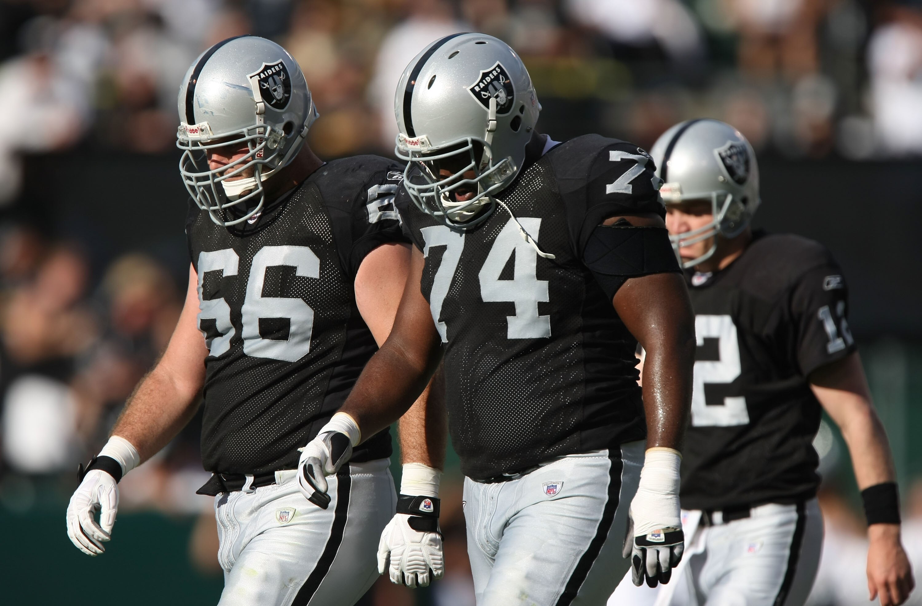OAKLAND, CA - NOVEMBER 4: Cooper Carlisle #66, Cornell Green #74 and Josh McCown #12 of the Oakland Raiders leave the field against the Houston Texans at McAfee Coliseum November 4, 2007 in Oakland, California.  (Photo by Jed Jacobsohn/Getty Images)