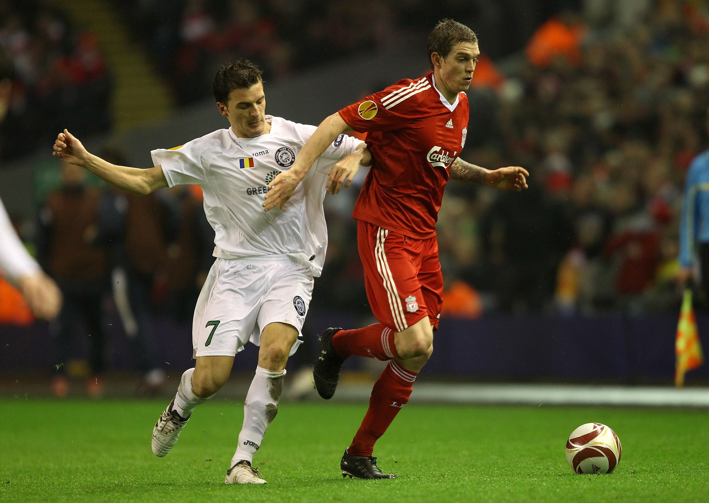 LIVERPOOL, ENGLAND - FEBRUARY 18:  Daniel Agger of Liverpool holds off a challenge from Marius Loan Bilasco of Unirea Urziceni during the UEFA Europa League Round 32 first leg match between Liverpool and Unirea Urzicen at Anfield on February 18, 2010 in L