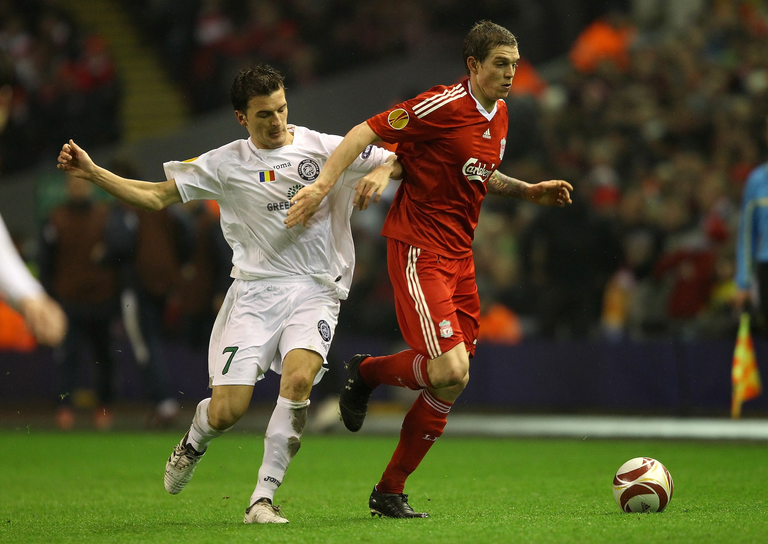 LIVERPOOL, ENGLAND - FEBRUARY 18:  Daniel Agger of Liverpool holds off a challenge from Marius Loan Bilasco of Unirea Urziceni during the UEFA Europa League Round 32 first leg match between Liverpool and Unirea Urzicen at Anfield on February 18, 2010 in L