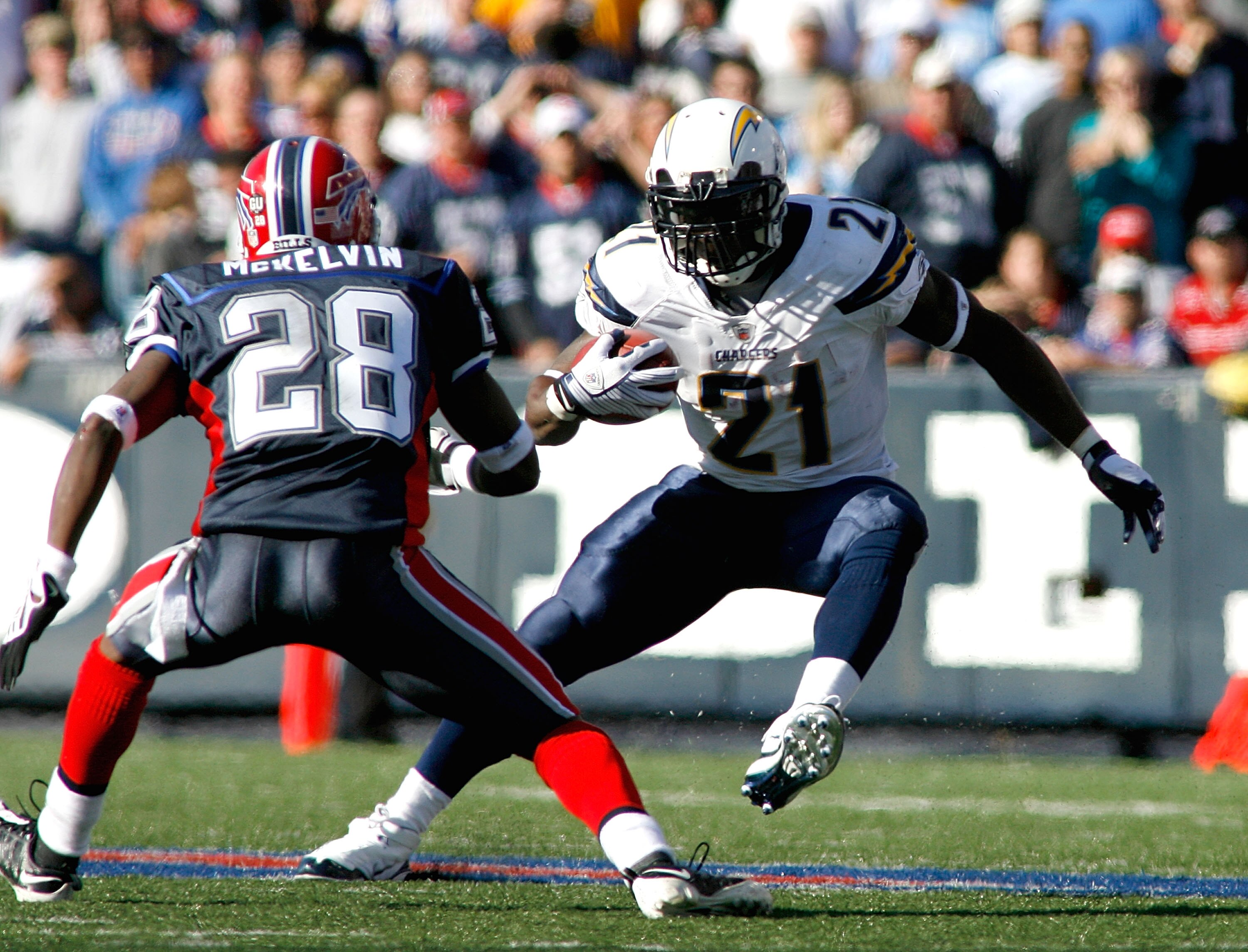 ORCHARD PARK, NY - OCTOBER 19: LaDanian Tomlinson #21 of the San Diego Chargers runs with pressure from Leodis McKelvin #28 of the Buffalo Bills  on October 19, 2008 at Ralph Wilson Stadium in Orchard Park, New York. Buffalo won 23-14.  (Photo by Rick Ste