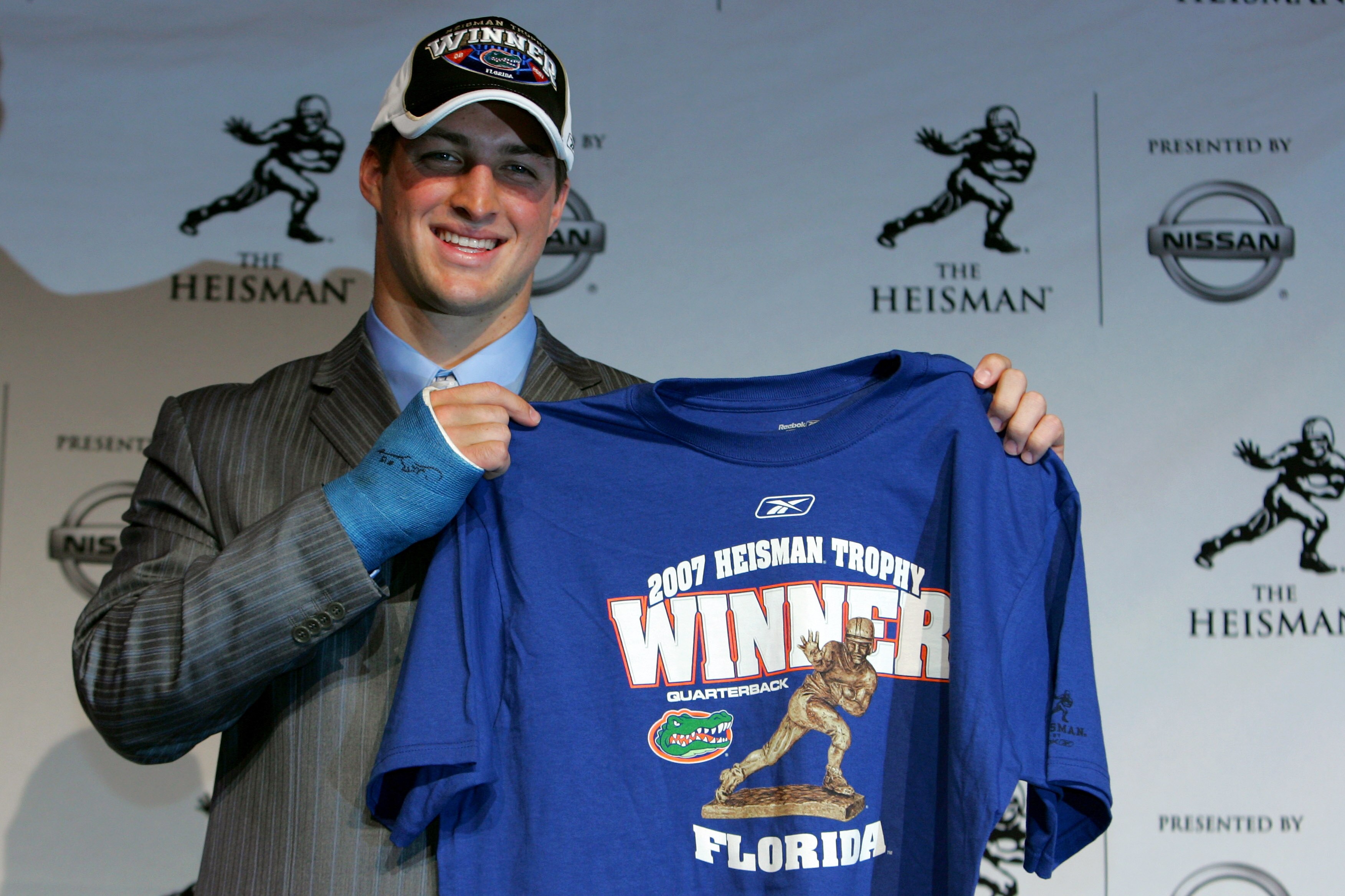 NEW YORK - DECEMBER 08:  Quarterback Tim Tebow of the University of Florida holds up a winners shirt after winning the 73rd Annual Heisman Memorial Trophy Award on December 8, 2007 in New York City.  (Photo by Chris Trotman/Getty Images)