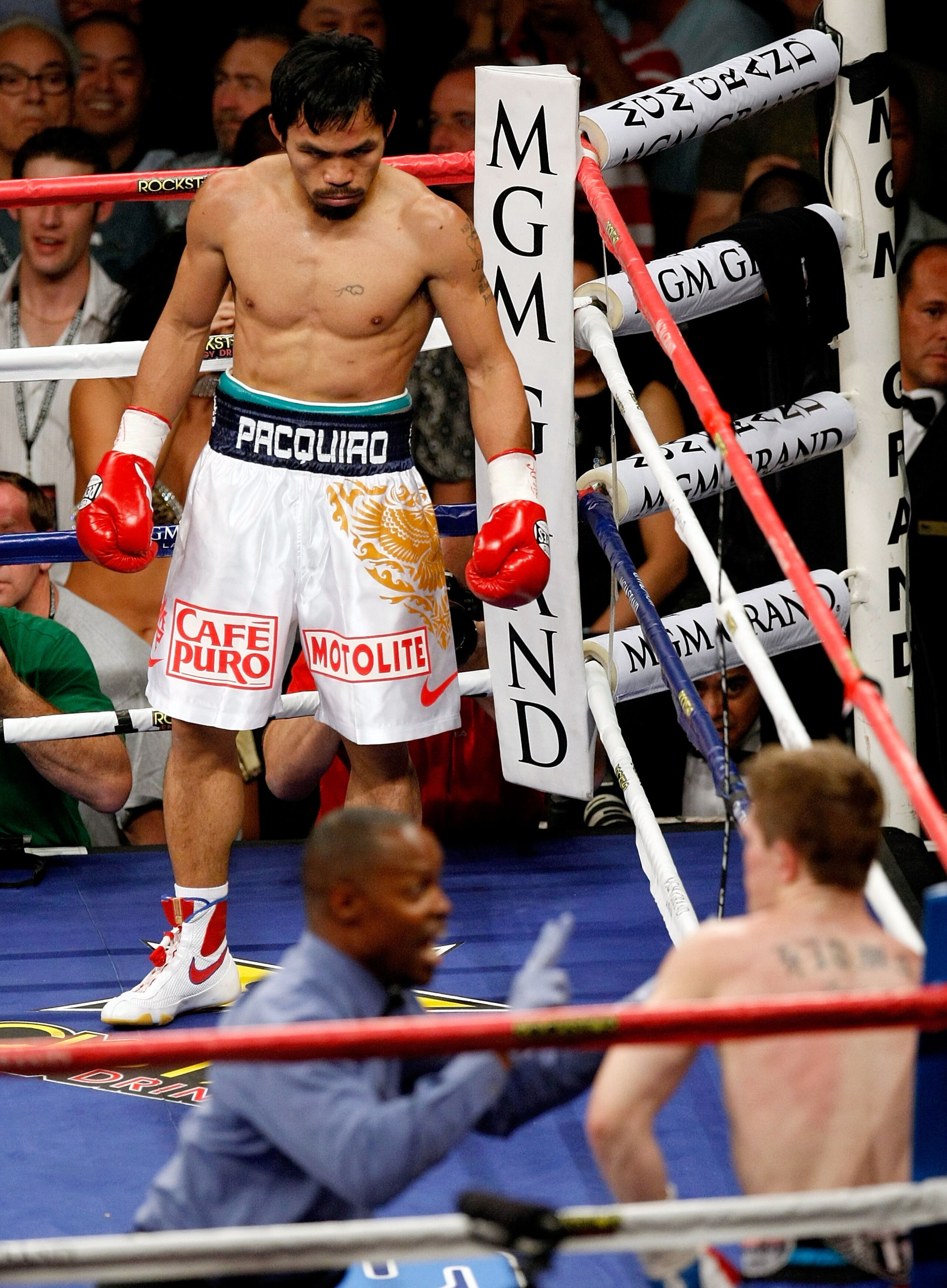 LAS VEGAS - MAY 02:  Manny Pacquiao of the Philippines looks down at referee Kenny Bayless counting after Ricky Hatton of England was knocked down in the first round during their junior welterweight title fight at the MGM Grand Garden Arena May 2, 2009 in