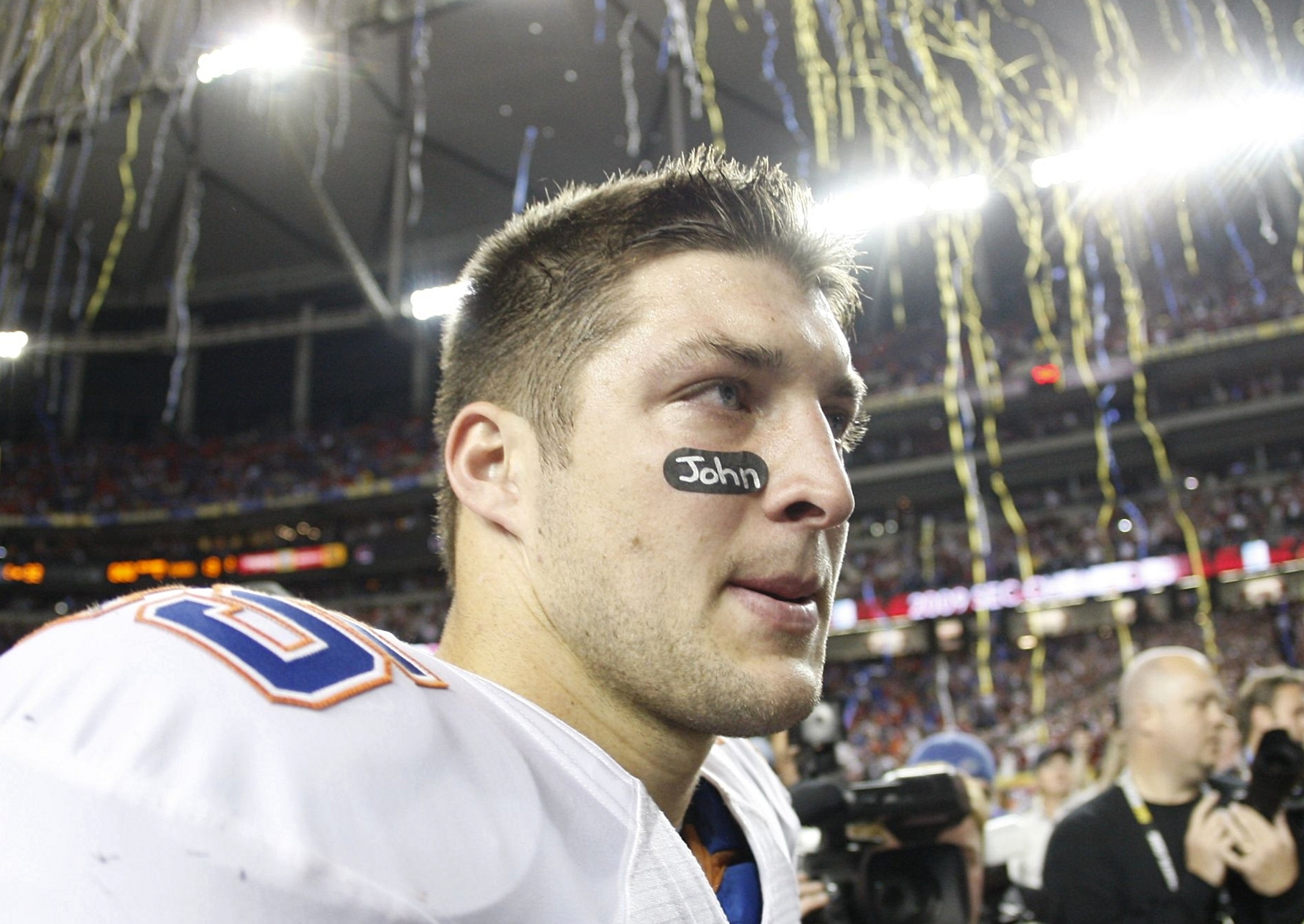 ATLANTA - DECEMBER 5:  Quarterback Tim Tebow #15 of the Florida Gators walks off the field as confetti falls after Florida lost 32-13 against the Alabama Crimson Tide during the SEC Championship game at Georgia Dome on December 5, 2009 in Atlanta, Georgia