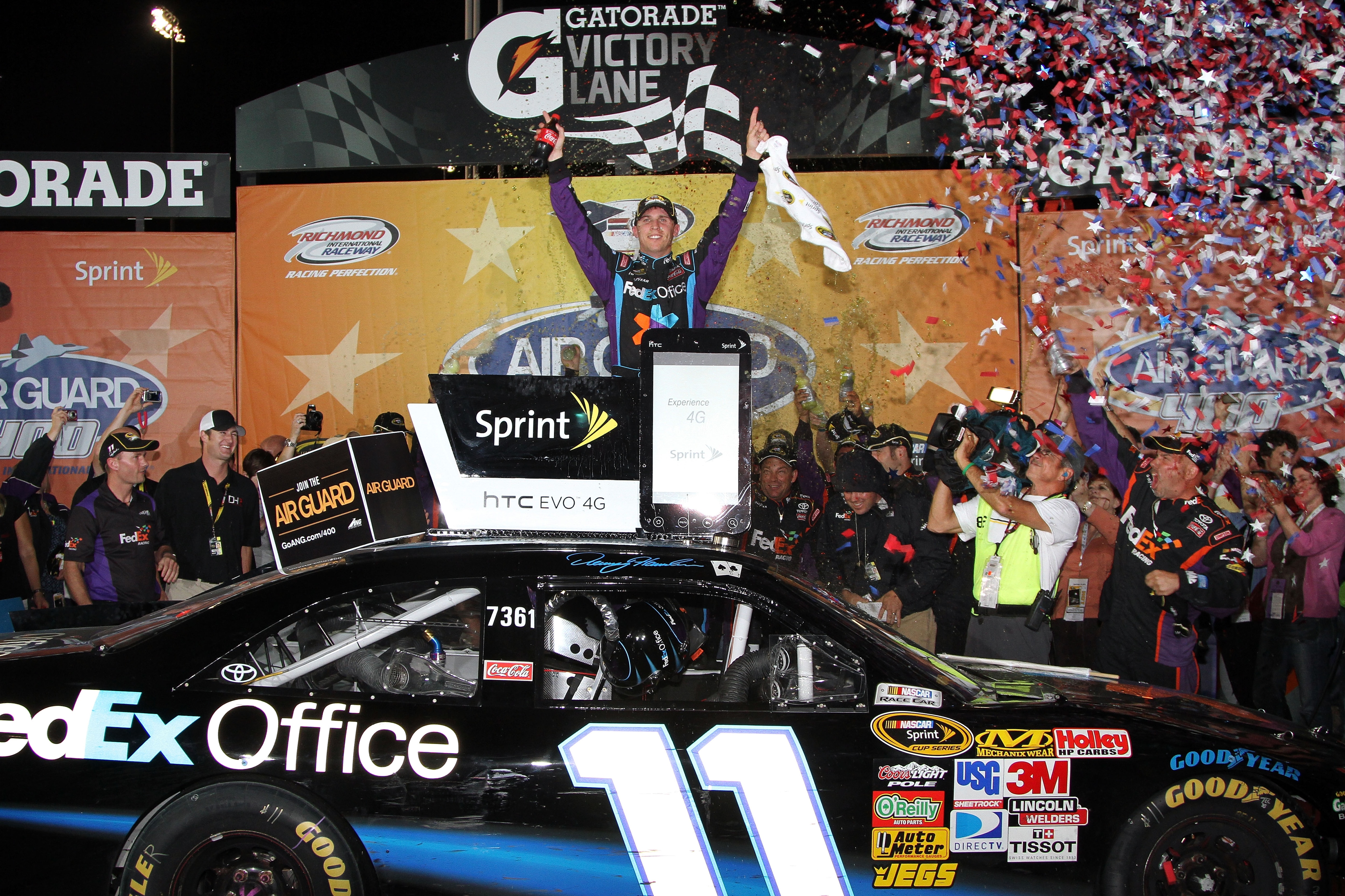 RICHMOND, VA - SEPTEMBER 11:  Denny Hamlin, driver of the #11 FedEx Office Toyota, celebrates in Victory Lane after winning the NASCAR Sprint Cup Series Air Guard 400 at Richmond International Raceway on September 11, 2010 in Richmond, Virginia.  (Photo b