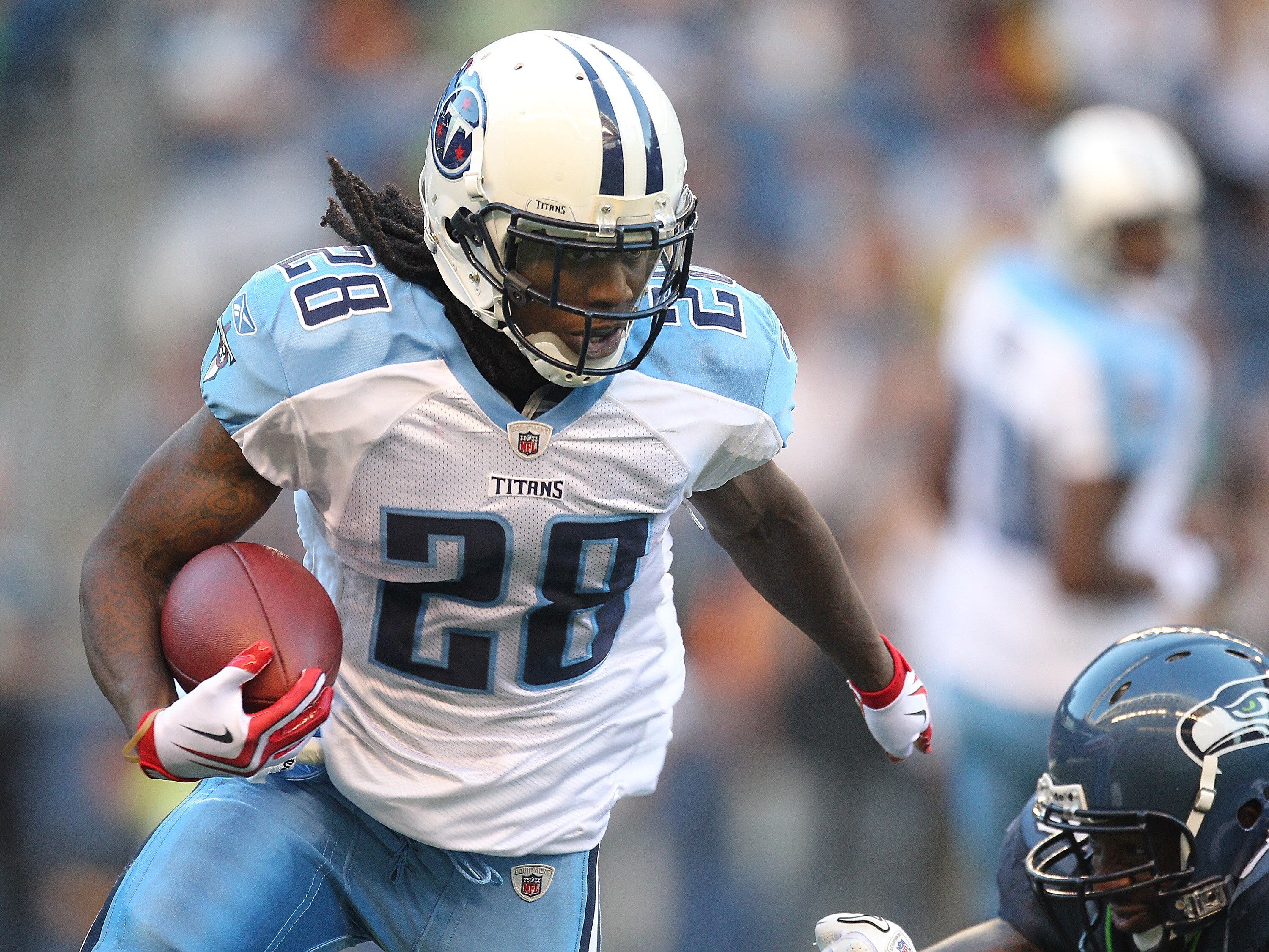 SEATTLE - AUGUST 14: Running back Chris Johnson #28 of the Tennessee Titans rushes against Aaron Curry #59 during the preseason game against the Seattle Seahawks at Qwest Field on August 14, 2010 in Seattle, Washington. (Photo by Otto Greule Jr/Getty Imag