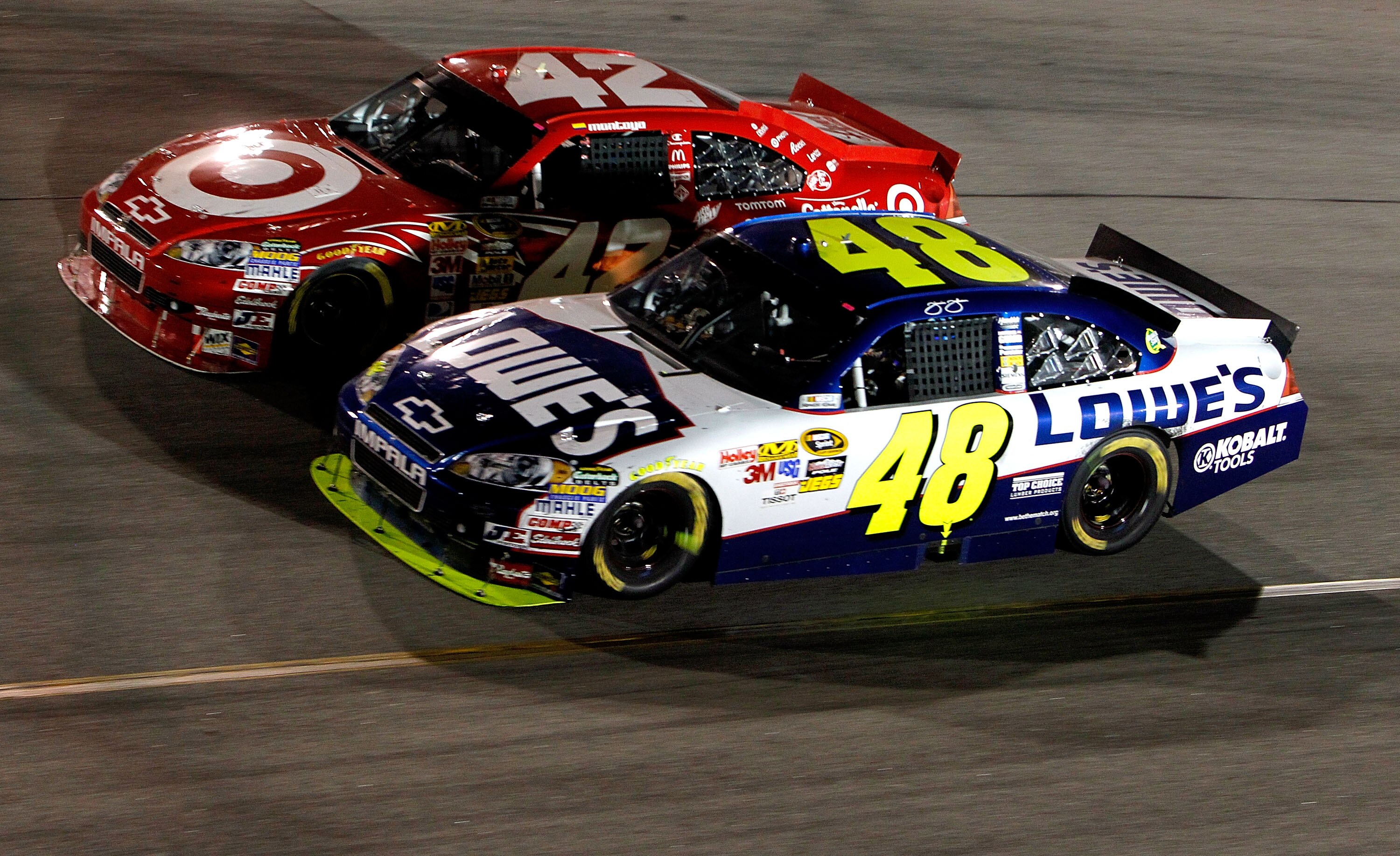 RICHMOND, VA - SEPTEMBER 11:  Jimmie Johnson, driver of the #48 Lowe's Chevrolet, races with Juan Pablo Montoya, driver of the #42 Target Chevrolet during the NASCAR Sprint Cup Series Air Guard 400 at Richmond International Raceway on September 11, 2010 i