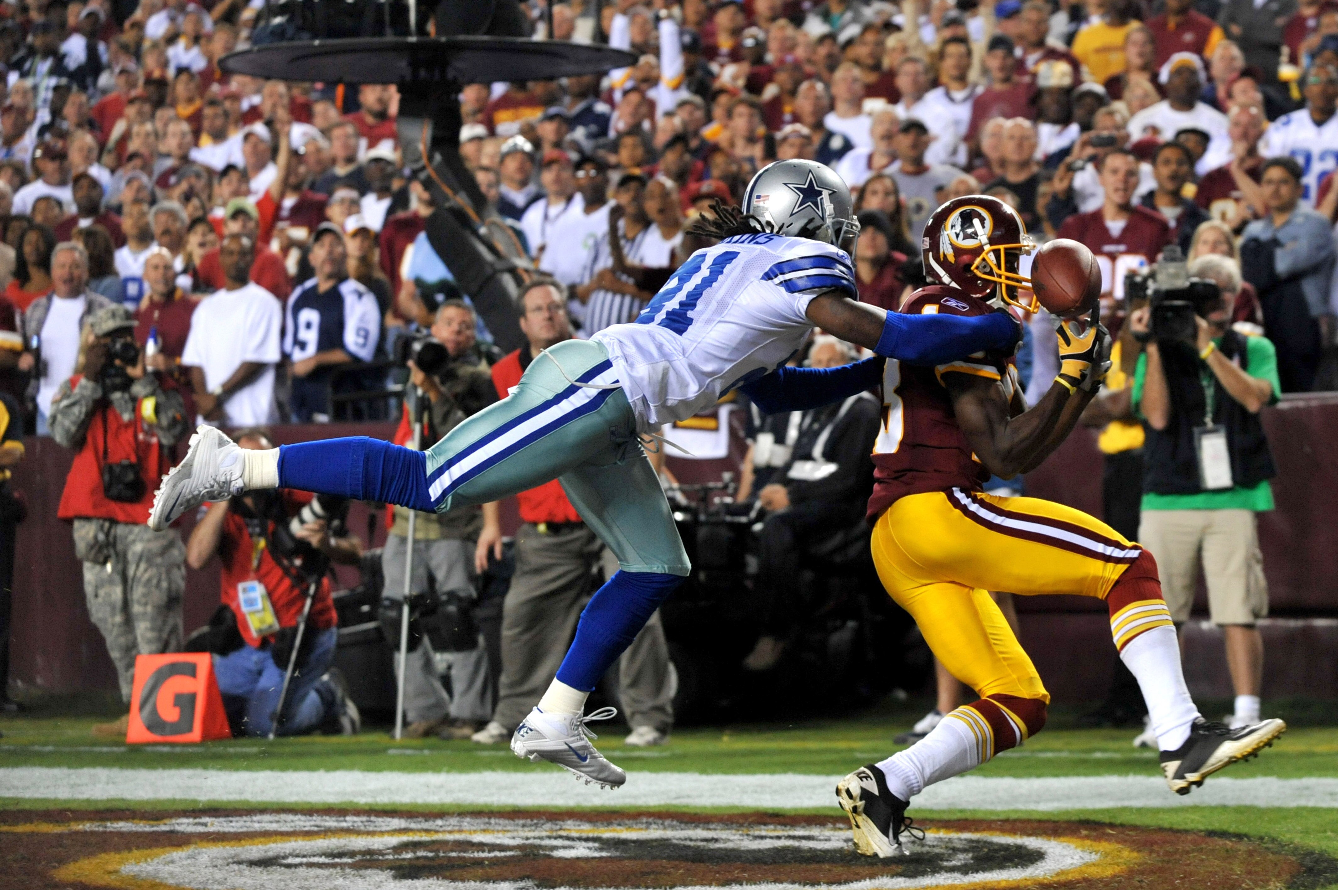 LANDOVER - SEPTEMBER 12:  Mike Jenkins #21 of the Dallas Cowboys knocks the ball loose from Anthony Armstrong #13 of the Washington Redskins during the NFL season opener against the Washington Redskins at FedExField on September 12, 2010 in Landover, Mary