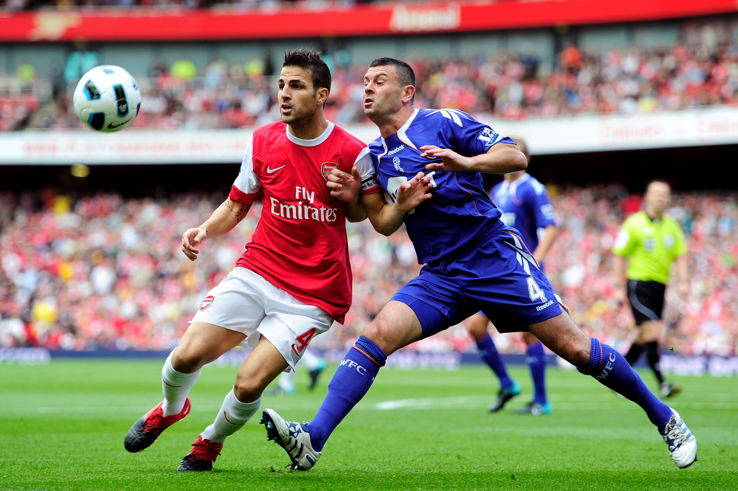 LONDON, ENGLAND - SEPTEMBER 11:  Cesc Fabregas of Arsenal battles with Paul Robinson of Bolton during the Barclays Premier League match between Arsenal and Bolton Wanderers at The Emirates Stadium on September 11, 2010 in London, England.  (Photo by Jamie
