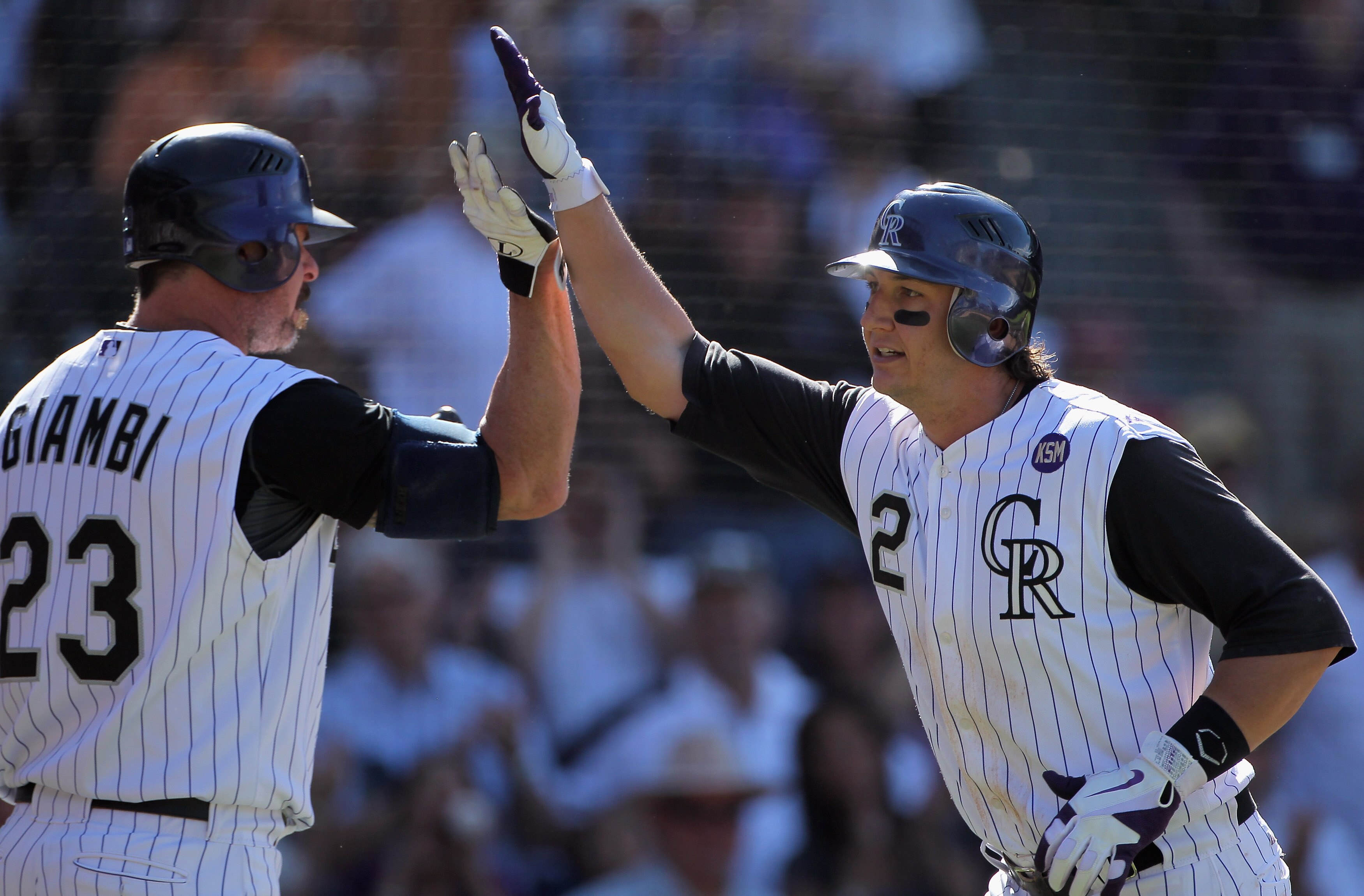 DENVER - SEPTEMBER 09:  Troy Tulowitzki #2 of the Colorado Rockies celebrates his eighth inning homerun off of pitcher Nick Masset of the Cincinnati Reds with Jason Giambi #23 at Coors Field on September 9, 2010 in Denver, Colorado. The Rockies defeated t