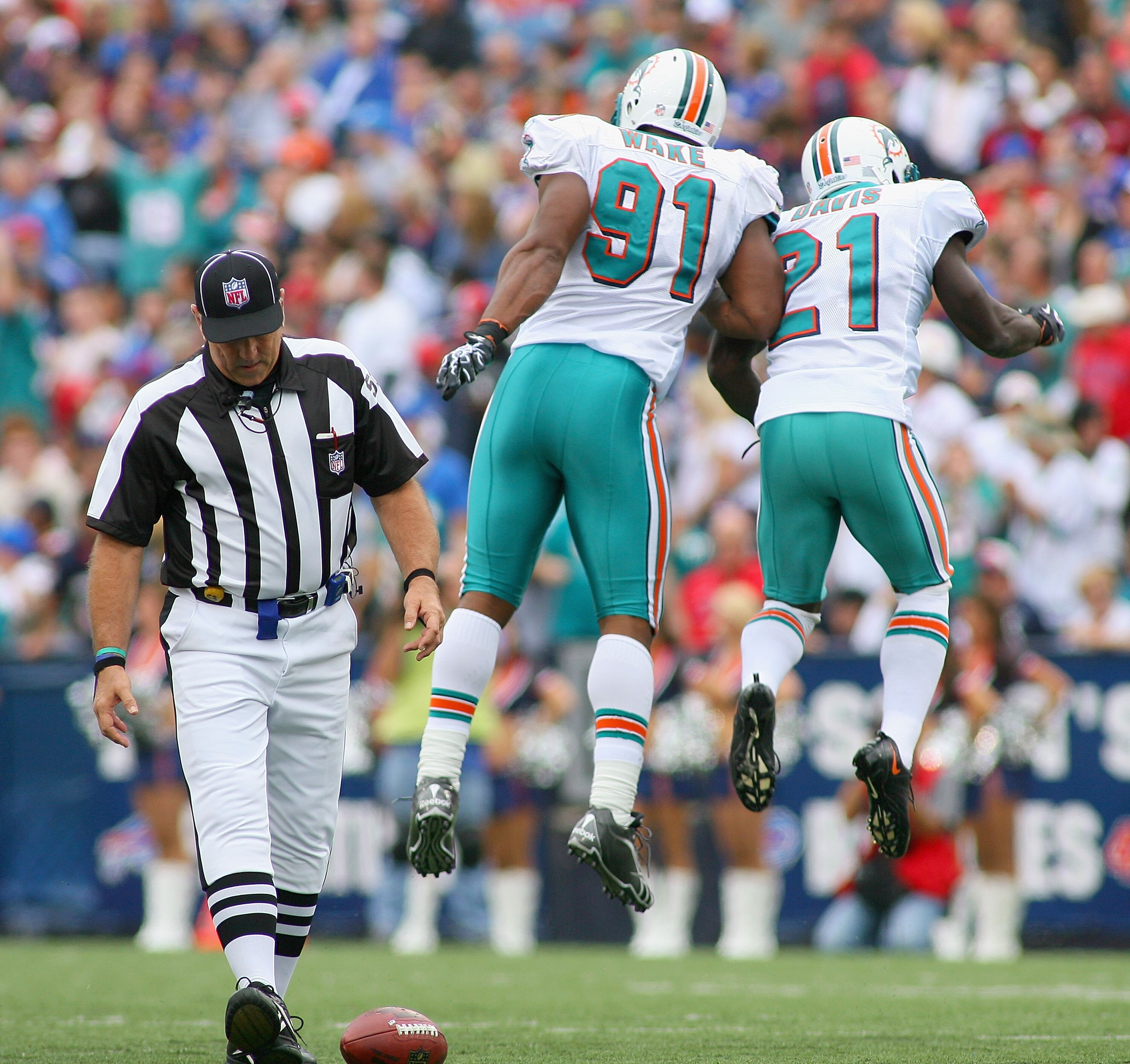 ORCHARD PARK, NY - SEPTEMBER 12: Cameron Wake #91 and Vontae Davis #21 of the Miami Dolphins celebrate a sack against the Buffalo Bills during the NFL season opener at Ralph Wilson Stadium on September 12, 2010 in Orchard Park, New York. Miami won 15-10 ORCHARD PARK, NY - SEPTEMBER 12: Cameron Wake #91 and Vontae Davis #21 of the Miami Dolphins celebrate a sack against the Buffalo Bills during the NFL season opener at Ralph Wilson Stadium on September 12, 2010 in Orchard Park, New York. Miami won 15-10