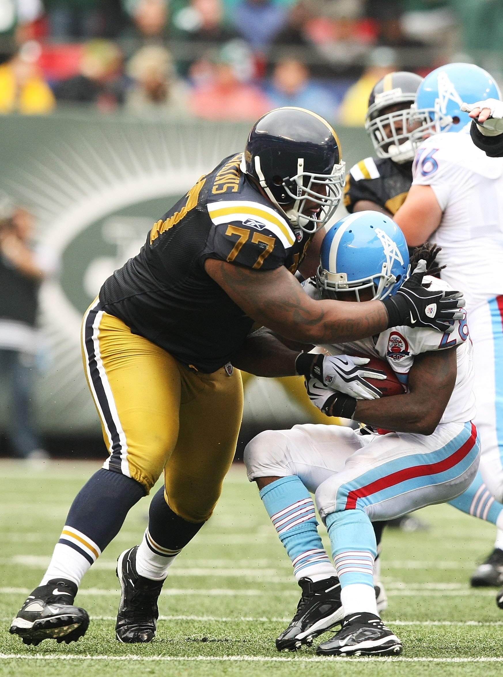 EAST RUTHERFORD, NJ - SEPTEMBER 27:  Kris Jenkins #77 of The New York Jets tackles Chris Johnson #28 of The Tennessee Titans during their game on September 27, 2009 at Giants Stadium in East Rutherford, New Jersey.  (Photo by Al Bello/Getty Images)