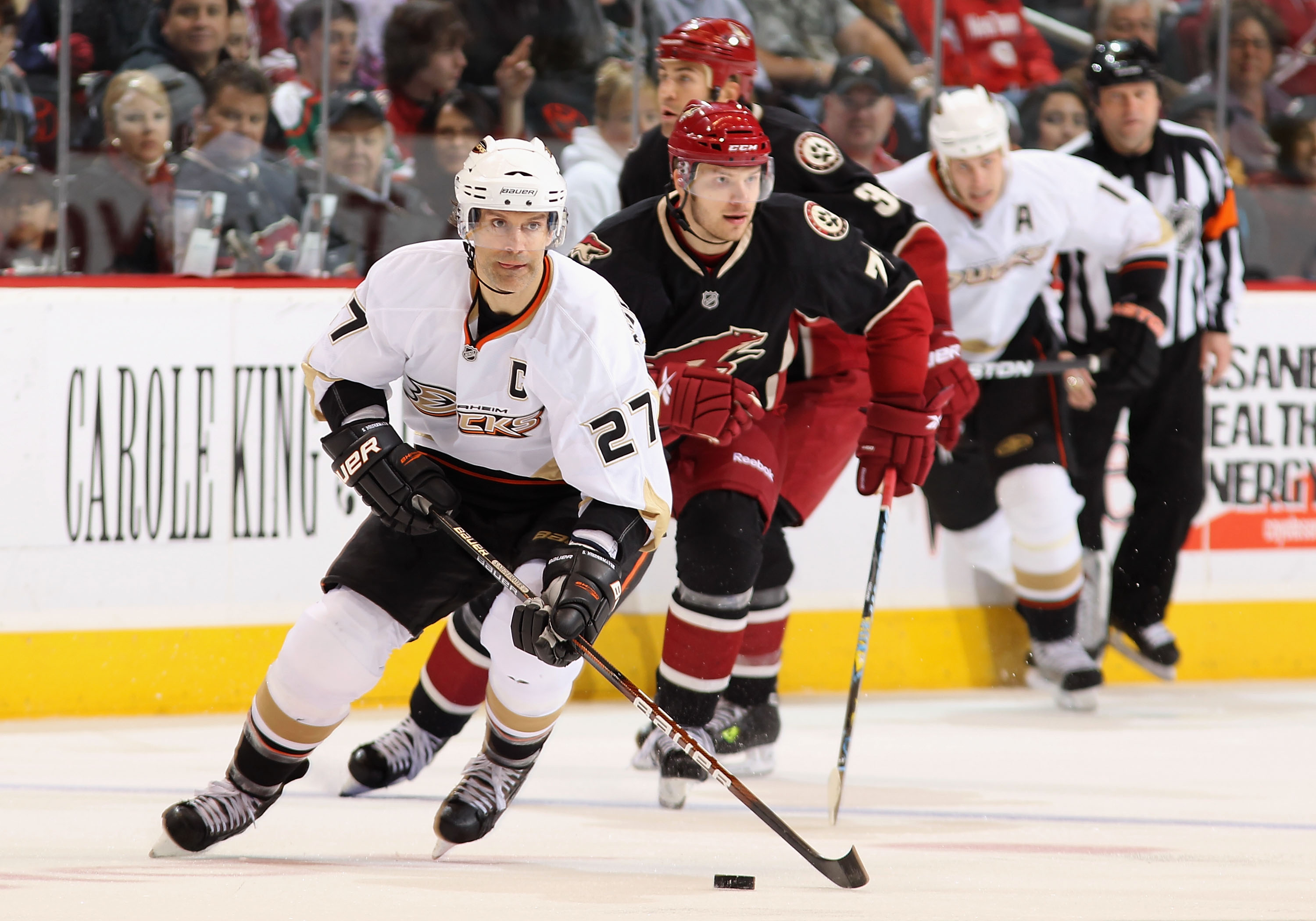 GLENDALE, AZ - MARCH 06:  Scott Niedermayer #27 of the Anaheim Ducks skates with the puck past Petteri Nokelainen #71 of the Phoenix Coyotes during the third period of the NHL game at Jobing.com Arena on March 6, 2010 in Glendale, Arizona.  The Coyotes de