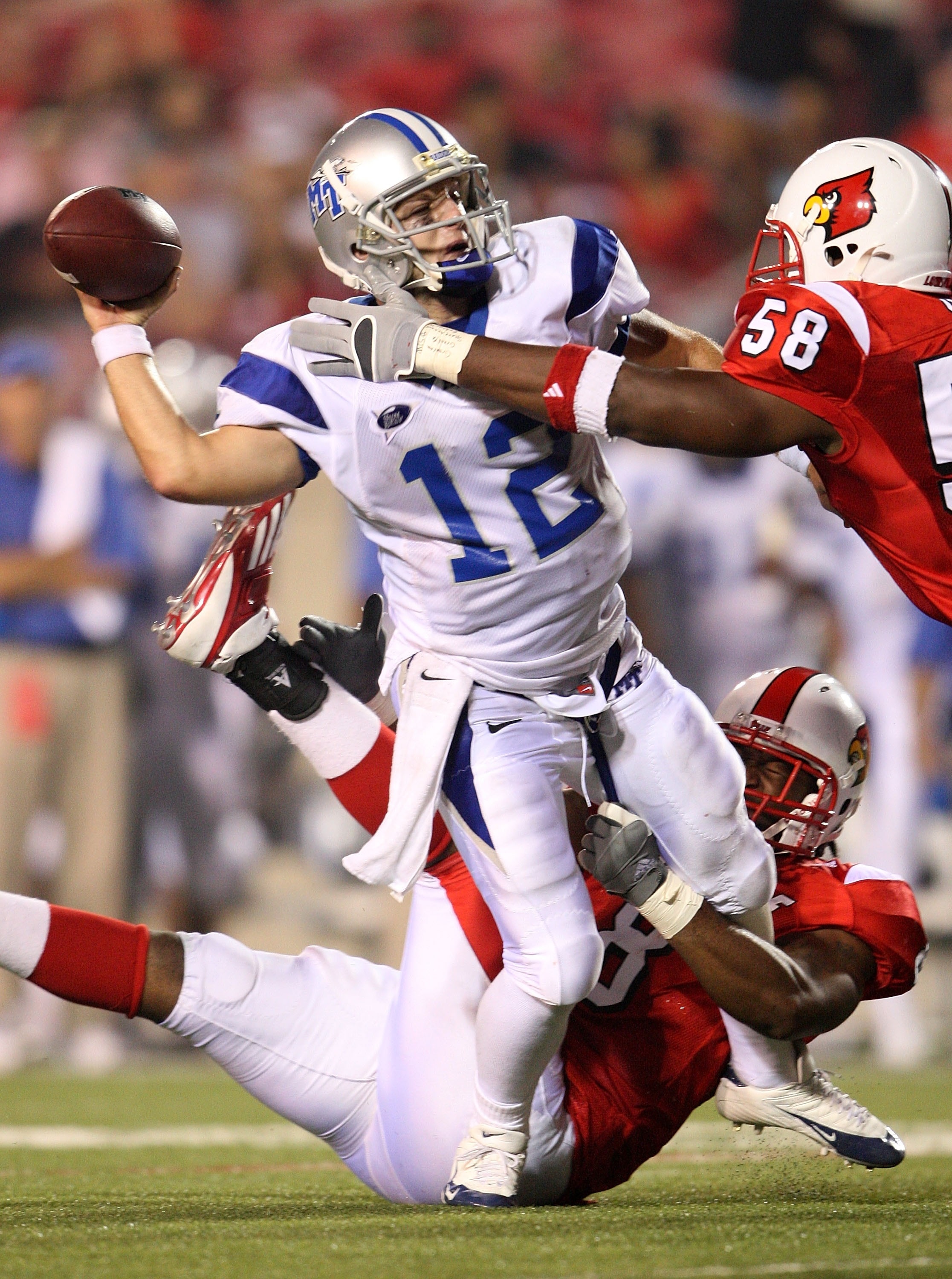 LOUISVILLE, KY - SEPTEMBER 06: Peanut Whitehead #8 and Rodney Gnat #58 of Louisville put pressure on Joe Craddock #12 of Middle Tennessee during the game on September 6, 2007 at Papa John's Cardinal Stadium in Louisville , Kentucky.  (Photo by Andy Lyons/