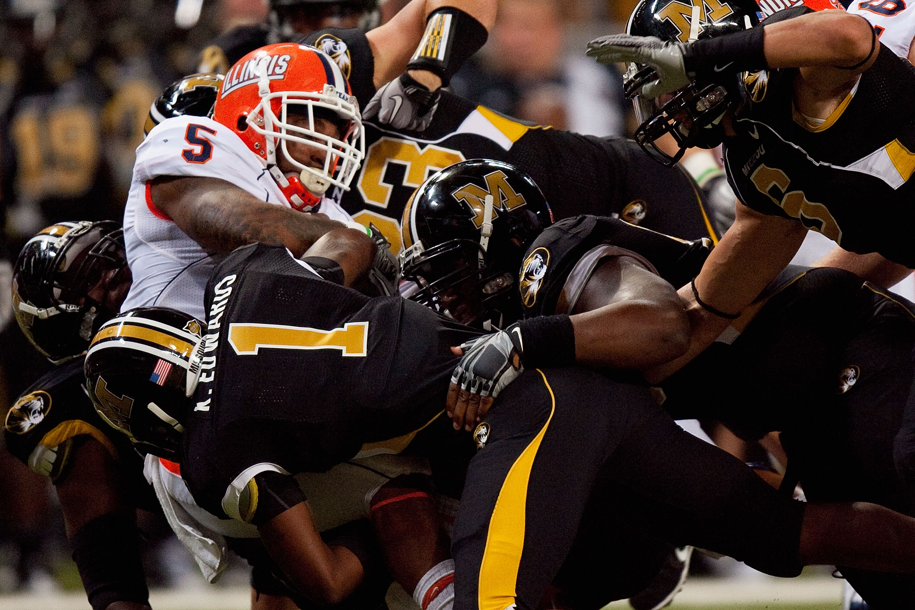 ST. LOUIS - SEPTEMBER 4: Mikel Leshoure #5 of the University of Illinois Fighting Illini is tackled against the University of Missouri Tigers during the State Farm Arch Rivalry game on September 4, 2010 at the Edward Jones Dome in St. Louis, Missouri. The