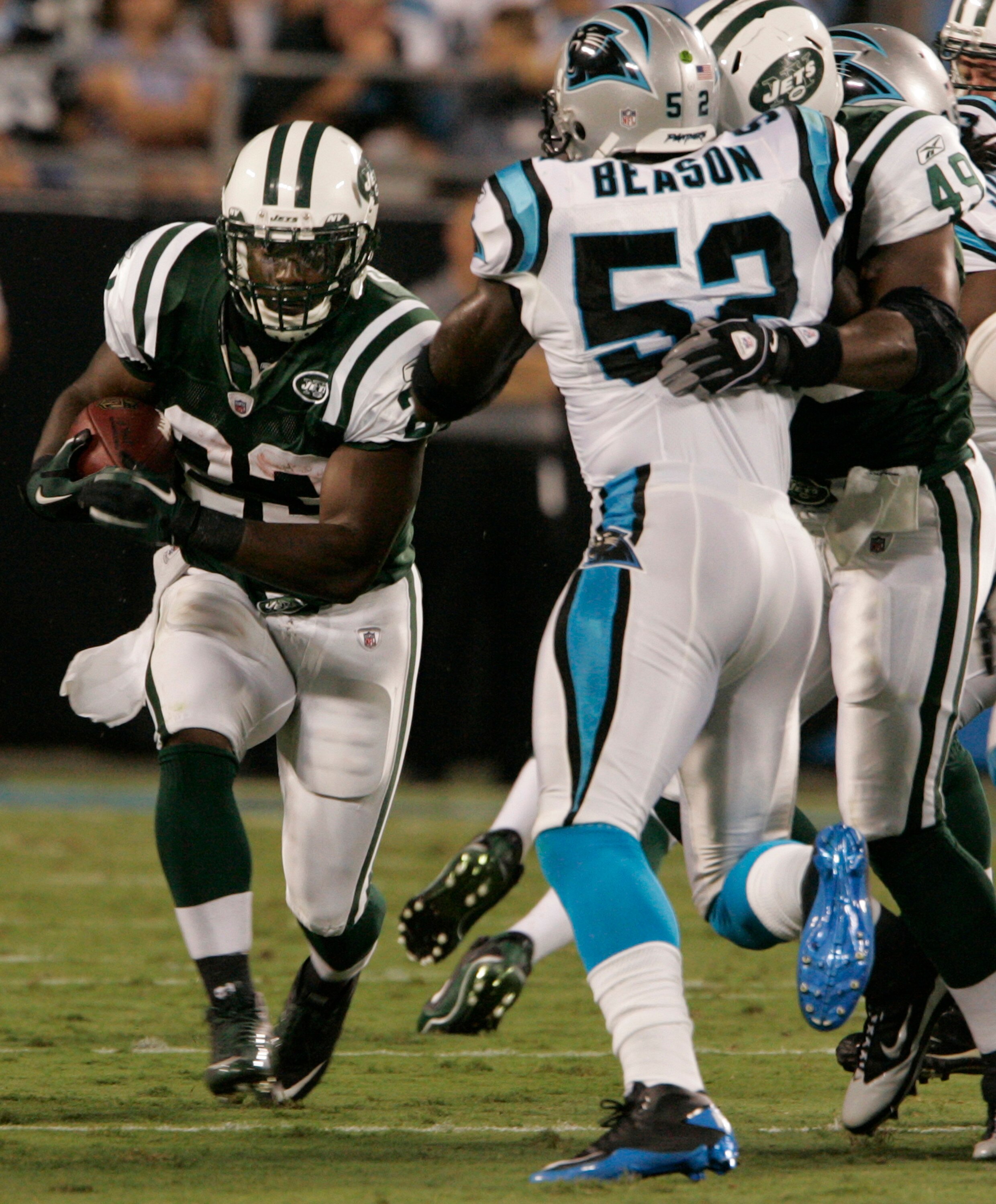 CHARLOTTE,NC - AUGUST 21:  Shonn Greene #23 of the New York Jets runs with the ball as Tony Richardson #49 holds off Jan Beason #52 of the Carolina Panthers during a preseason game at Bank of America Stadium on August 21, 2010 in Charlotte, North Carolina
