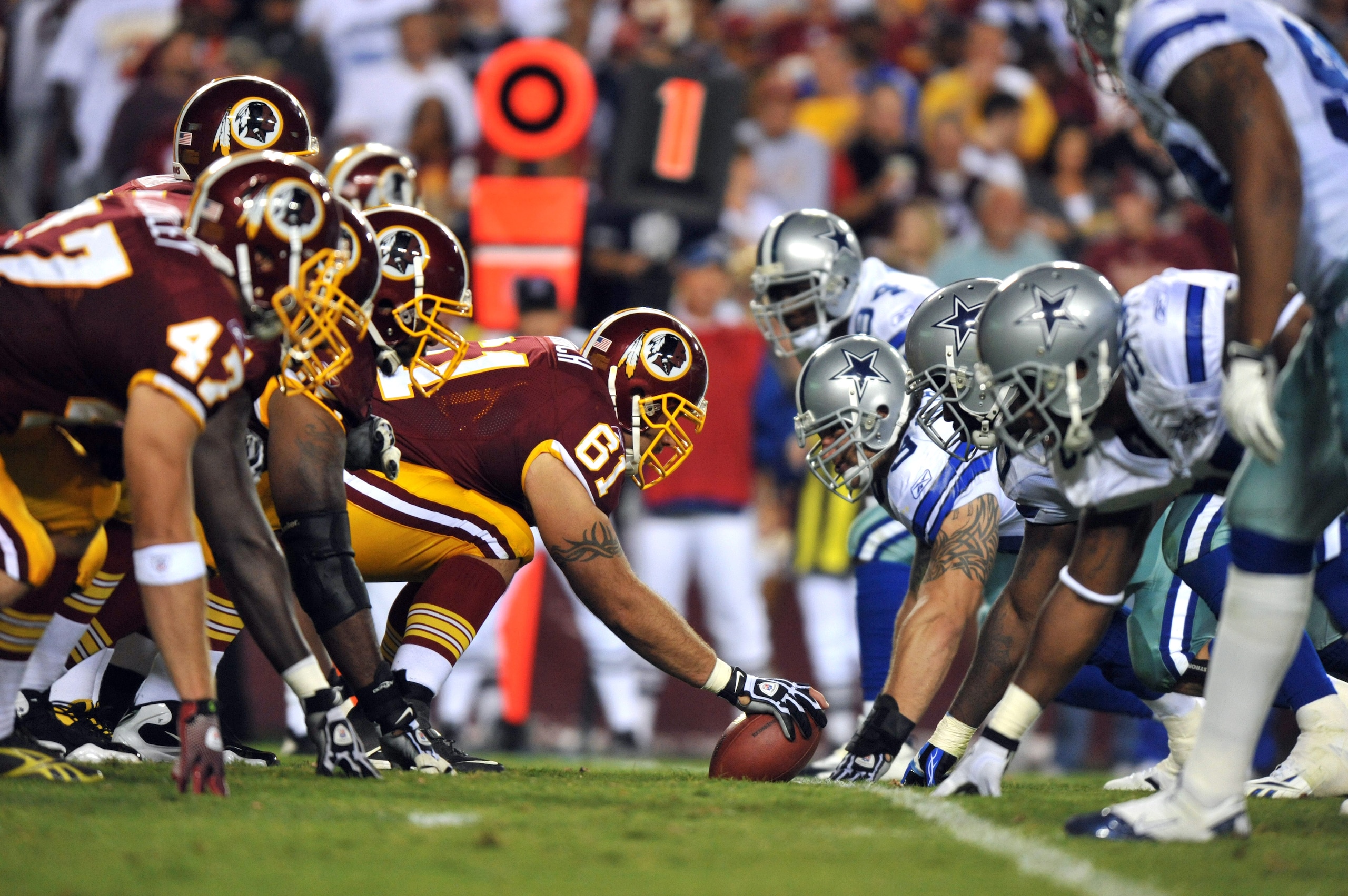 LANDOVER - SEPTEMBER 12:  Casey Rabach #61 of the Washington Redskins snaps the ball during the NFL season opener against the Dallas Cowboys at FedExField on September 12, 2010 in Landover, Maryland. The Redskins defeated the Cowboys 13-7. (Photo by Larry