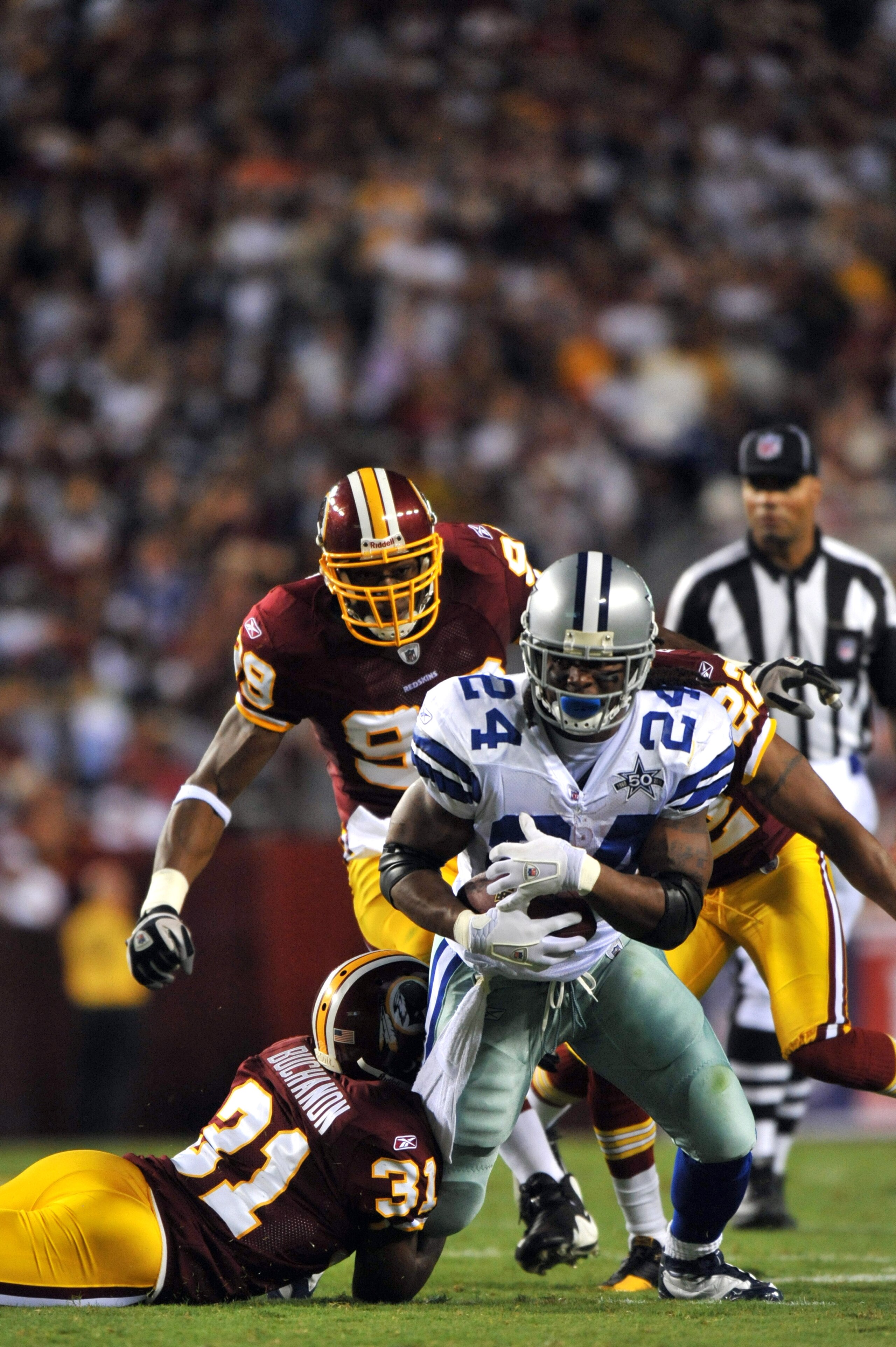 LANDOVER - SEPTEMBER 12:  Marion Barber #24 of the Dallas Cowboys runs the ball during the NFL season opener while Philip Buchanon #31 of the Washington Redskins defends at FedExField on September 12, 2010 in Landover, Maryland. The Redskins defeated the