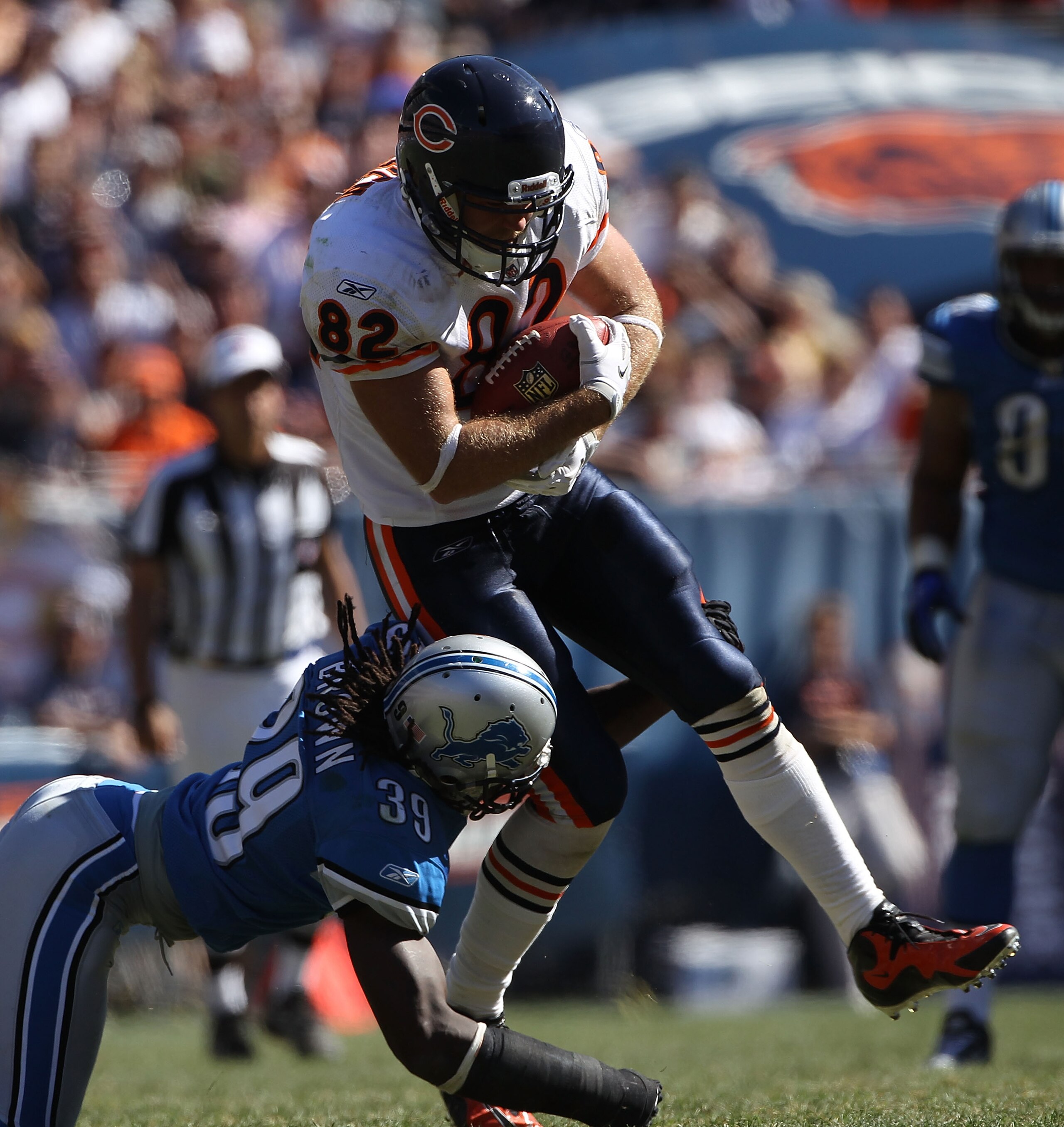 CHICAGO - SEPTEMBER 12: Greg Olsen #82 of the Chicago Bears grabs a pass for a first down as C.C. Brown #39 of the Detroit Lions goes for the tackle during the NFL season opening game at Soldier Field on September 12, 2010 in Chicago, Illinois. The Bears 